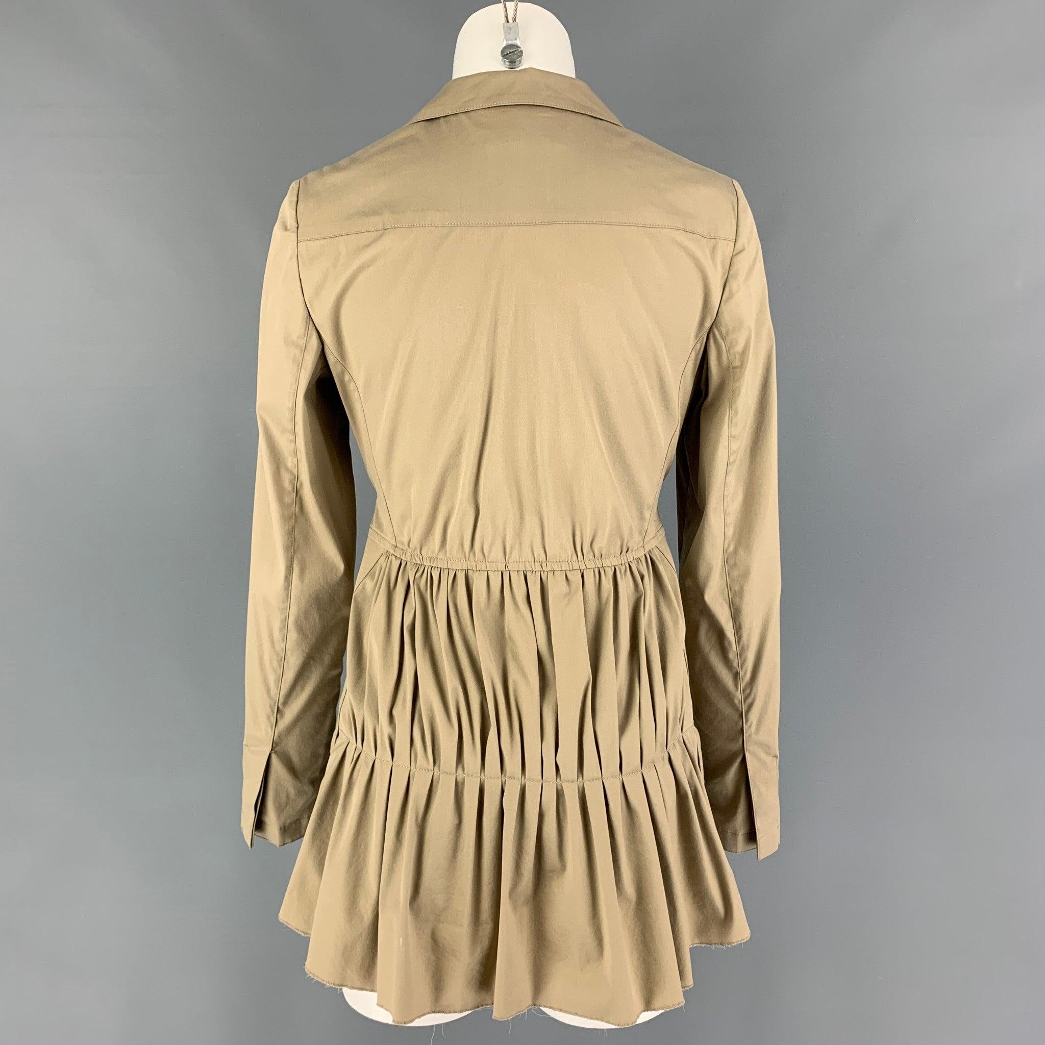 PRADA jacket comes in a beige cotton blend featuring a notch lapel, ruched back design, belted, raw hem, front pockets, and a hidden placket closure. Made in Italy.
Excellent
Pre-Owned Condition. 

Marked:   40 

Measurements: 
 
Shoulder: 15 inches
