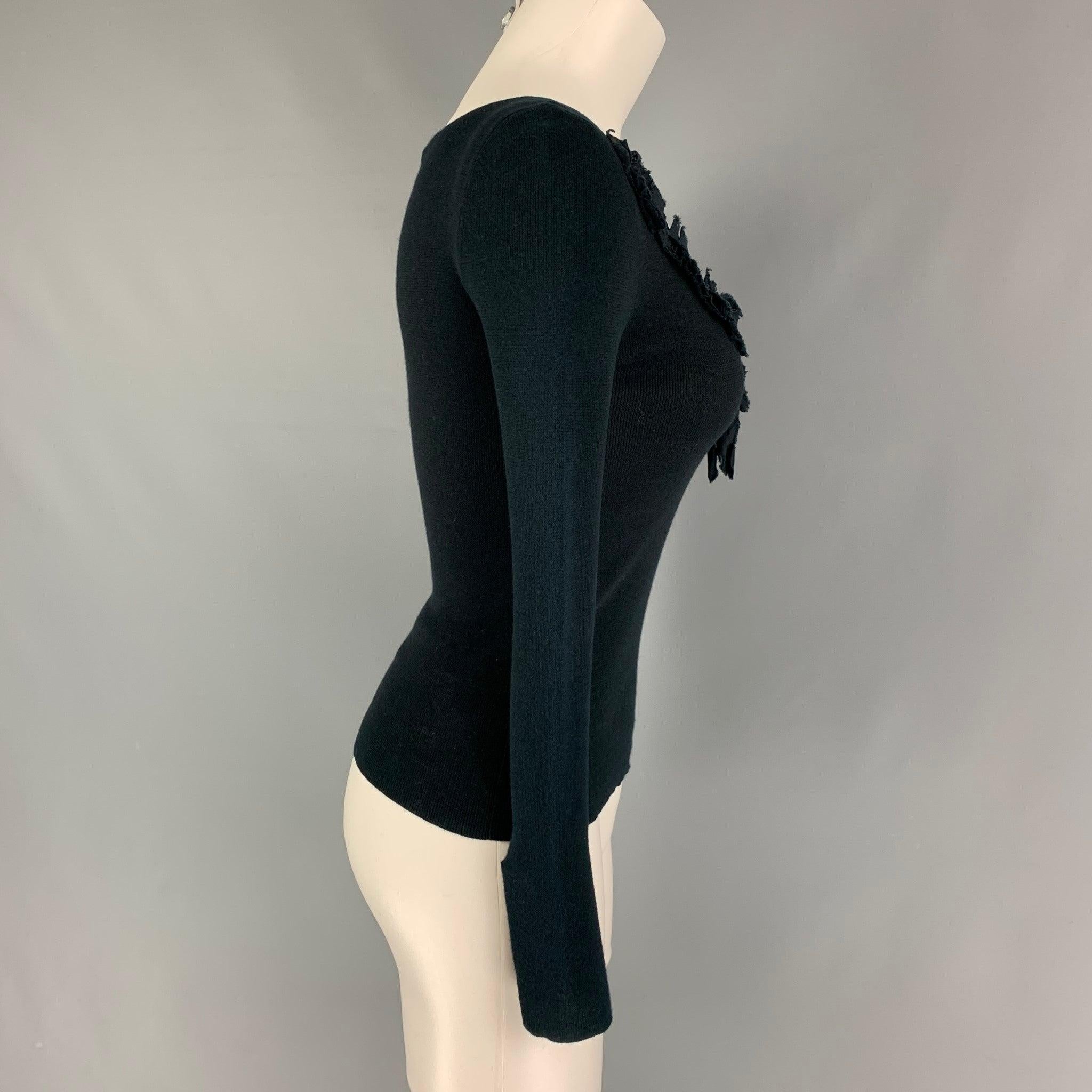 PRADA pullover comes in a black knitted material featuring a eyelet ribbon design and 3/4 sleeves. Made in Italy.
 Very Good
 Pre-Owned Condition. Fabric tag not visible.  
 

 Marked:  40 
 

 Measurements: 
  
 Shoulder: 14 inches Bust:
 28 inches
