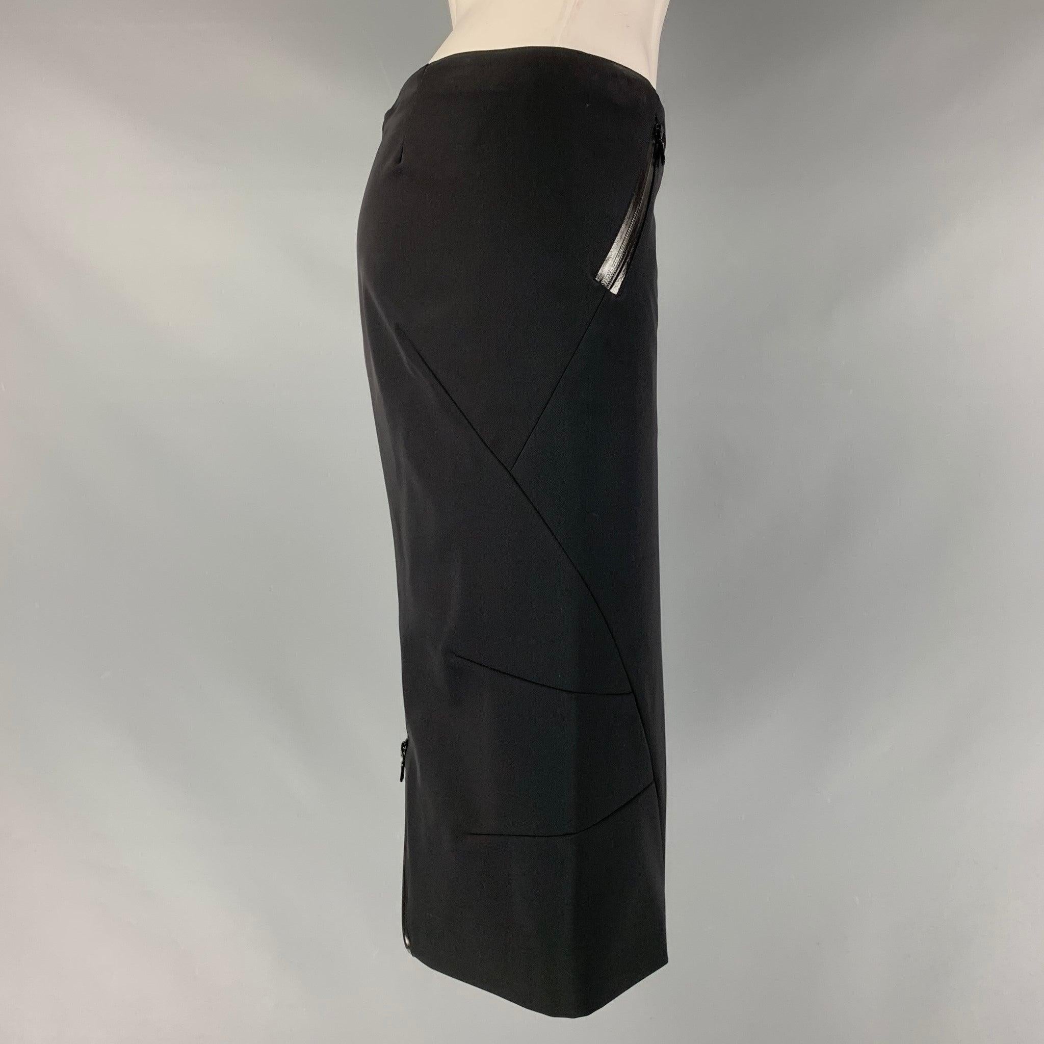 PRADA pencil skirt comes in a black polyester and elastane material featuring a water proof zippers, a slit at back and a center back invisible zip up closure. Very Good Pre-Owned Condition. Moderate mark at waistband. As-is. 
 

 Marked:  40 
 

