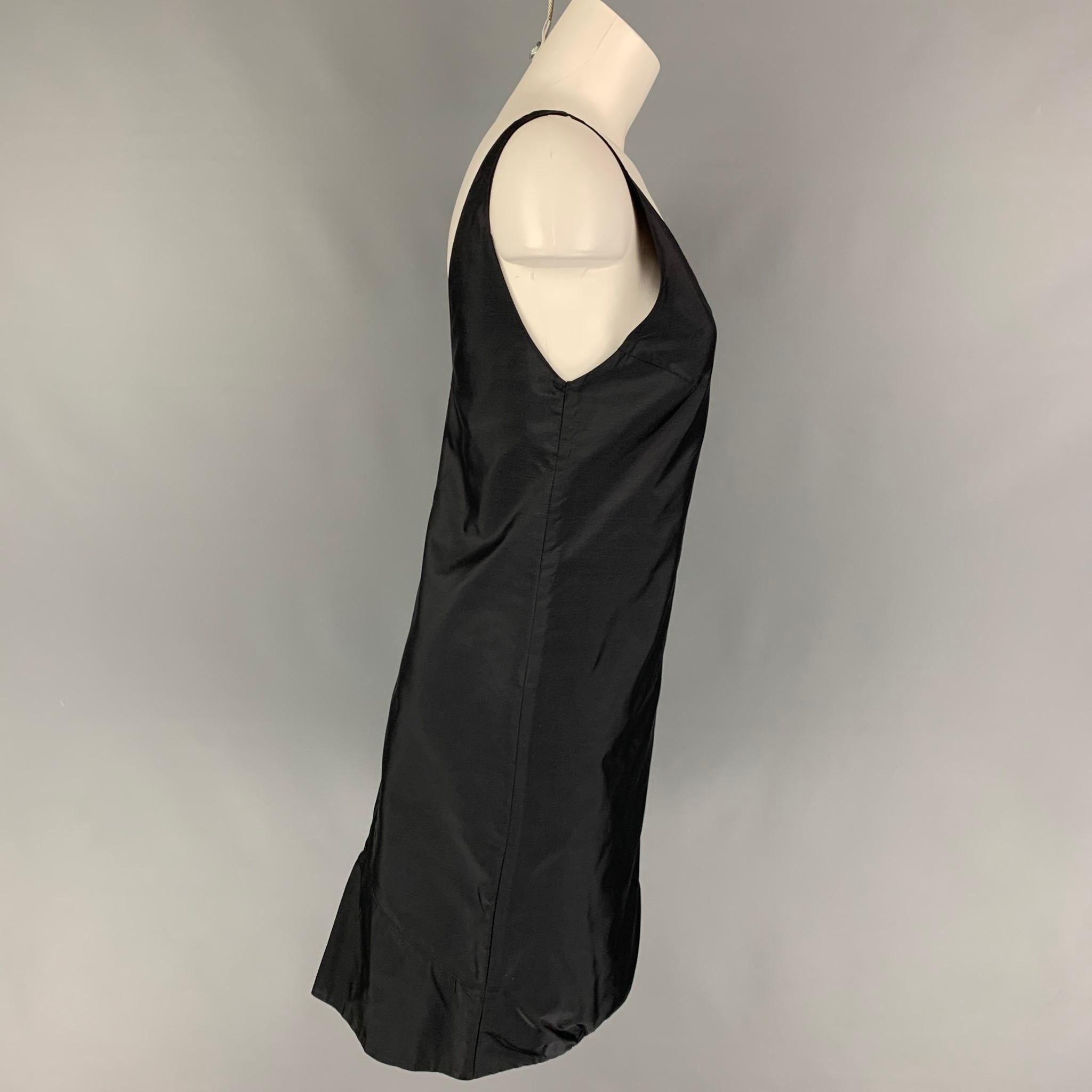 PRADA cocktail dress comes in a black silk featuring a bubble hem, v-neck, sleeveless, and a side snap button closure. Made in Italy. 

Very Good Pre-Owned Condition.
Marked: 40

Measurements:

Bust: 32 in.
Waist: 32 in.
Hip: 36 in.
Length: 36 in. 