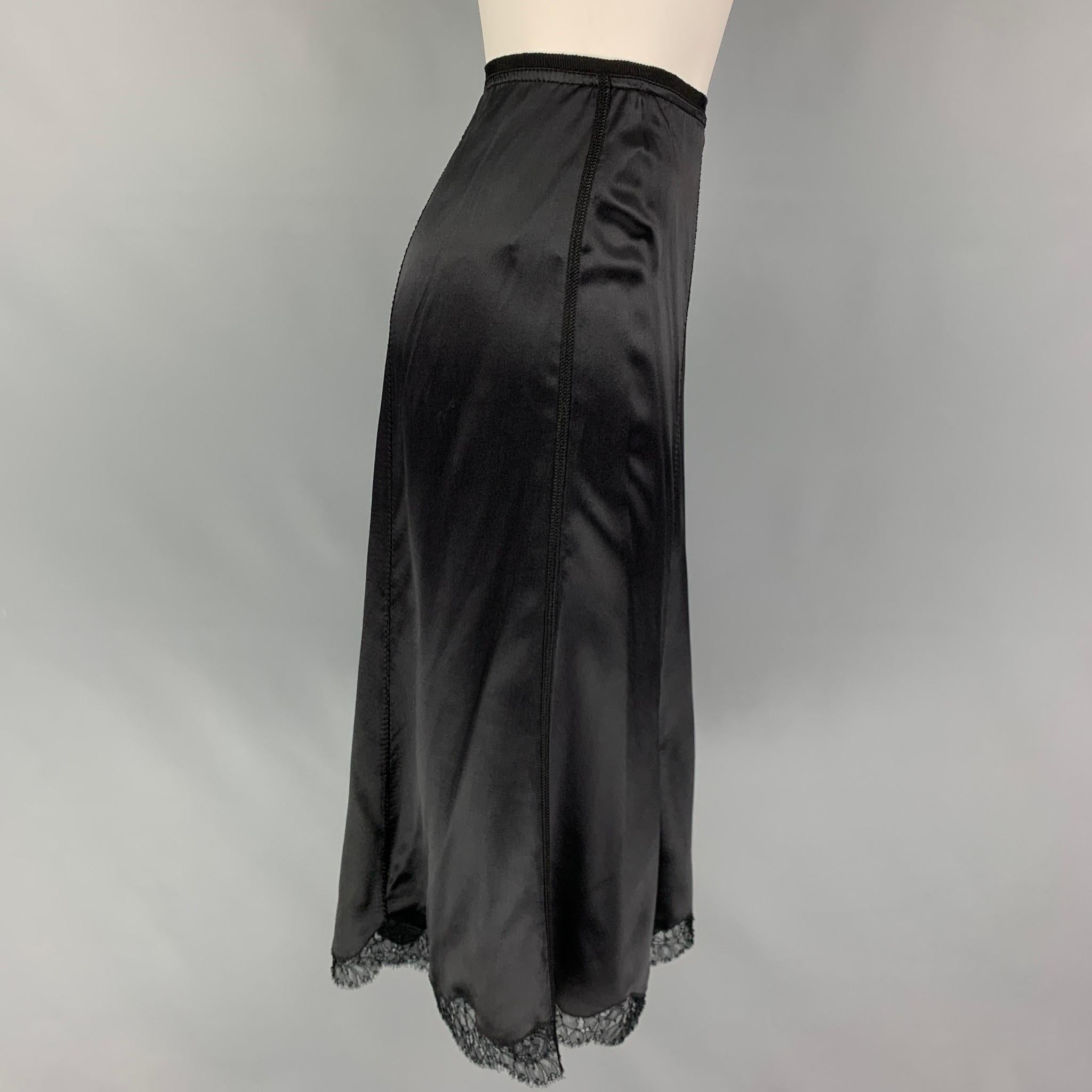 PRADA skirt comes in a black silk featuring a tulip style, lace trim, and a sie zipper closure. Made in Italy. 

Very Good Pre-Owned Condition.
Marked: 40

Measurements:

Waist: 28 in.
Hip: 40 in.
Length: 28.5 in. 
