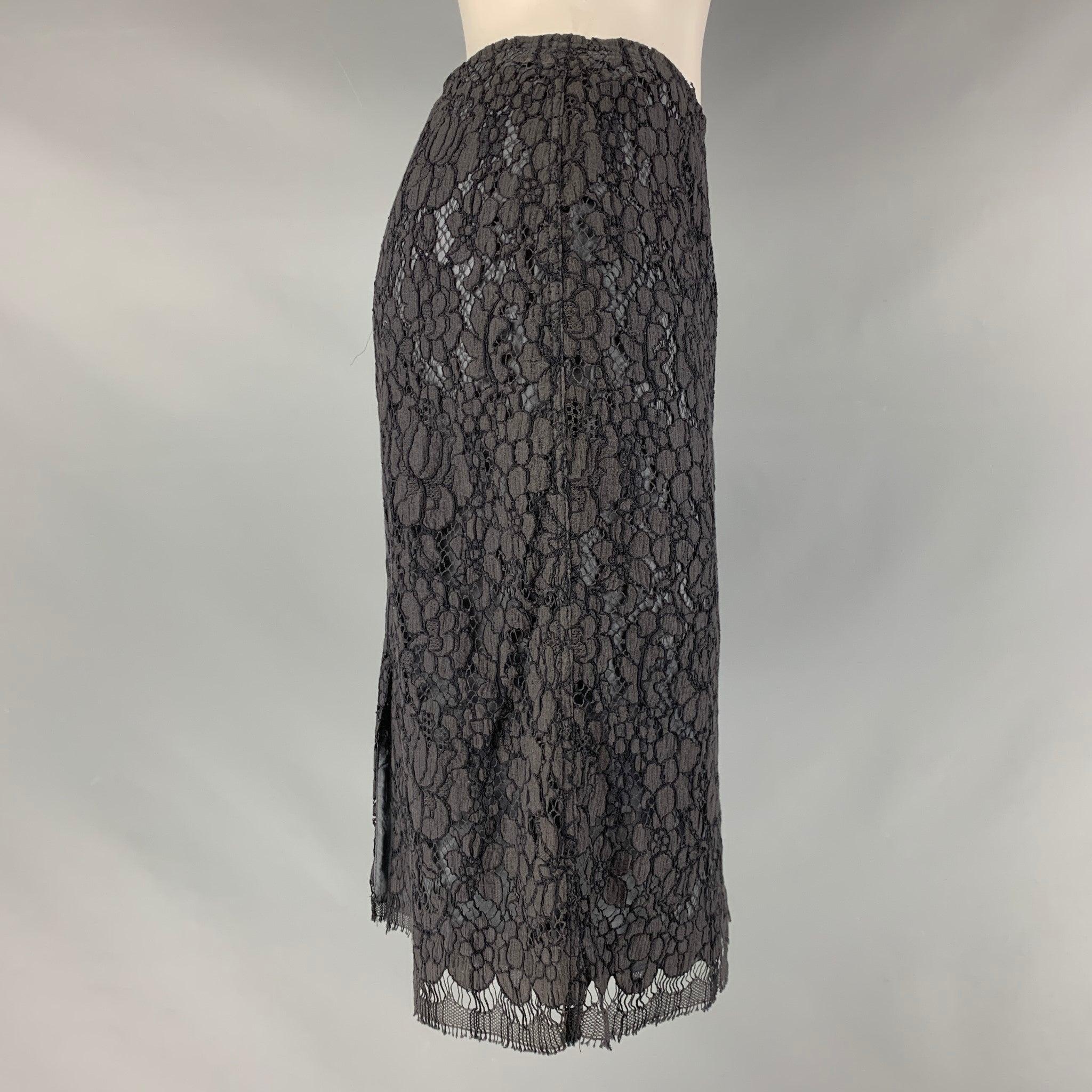 PRADA pencil skirt comes in a black lace material featuring a back slate and a center back invisible zip up closure. Made in Italy. Very Good Pre-Owned Condition. Moderate fading. 

Marked:   40 

Measurements: 
  Waist: 27 inches Hip: 35 inches