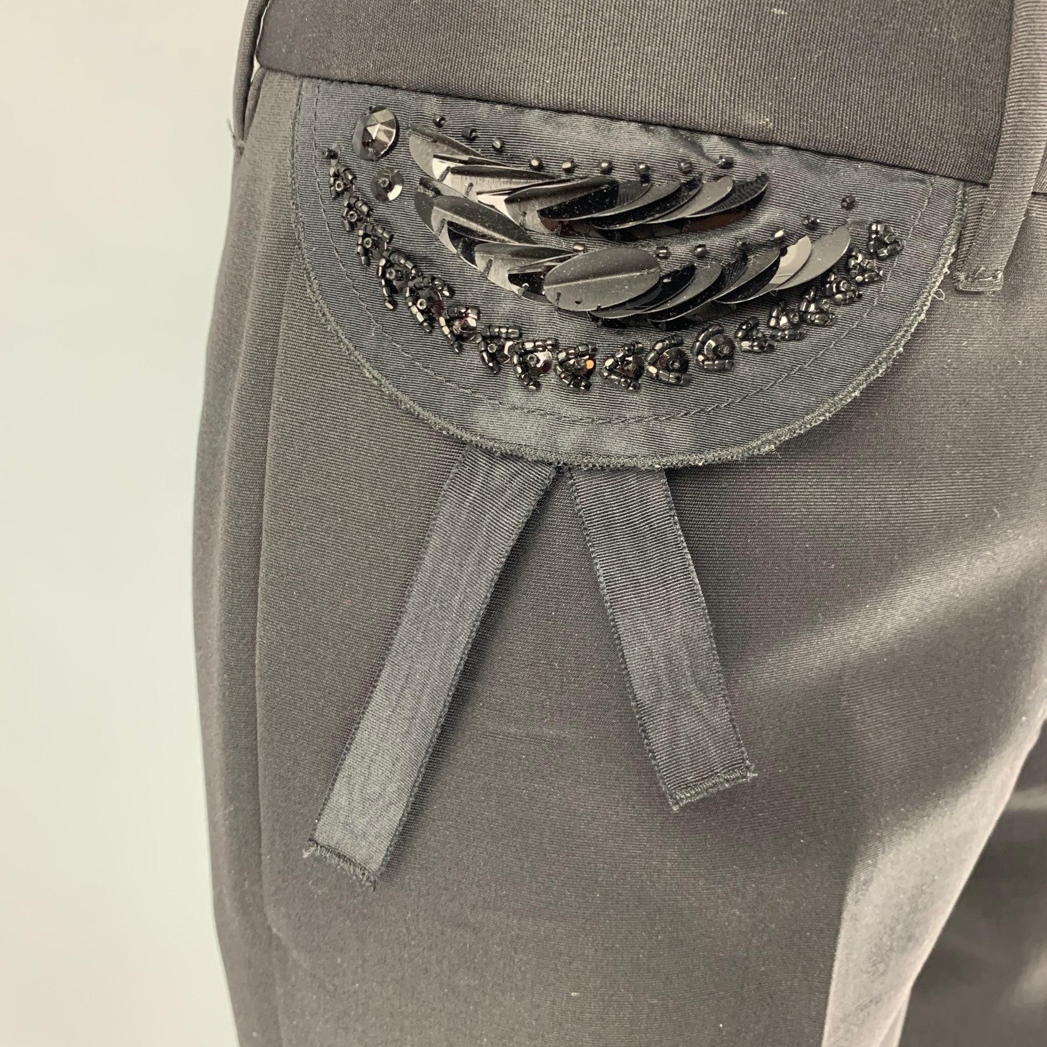 PRADA dress pants comes in a virgin wool featuring a beaded pocket detail, straight style, front tab, and a zip fly closure. Made in Italy.Good Pre-Owned Condition. Moderate Signs of Wear. As- Is. 

Marked:   I
40 

Measurements: 
  Waist: 29 inches