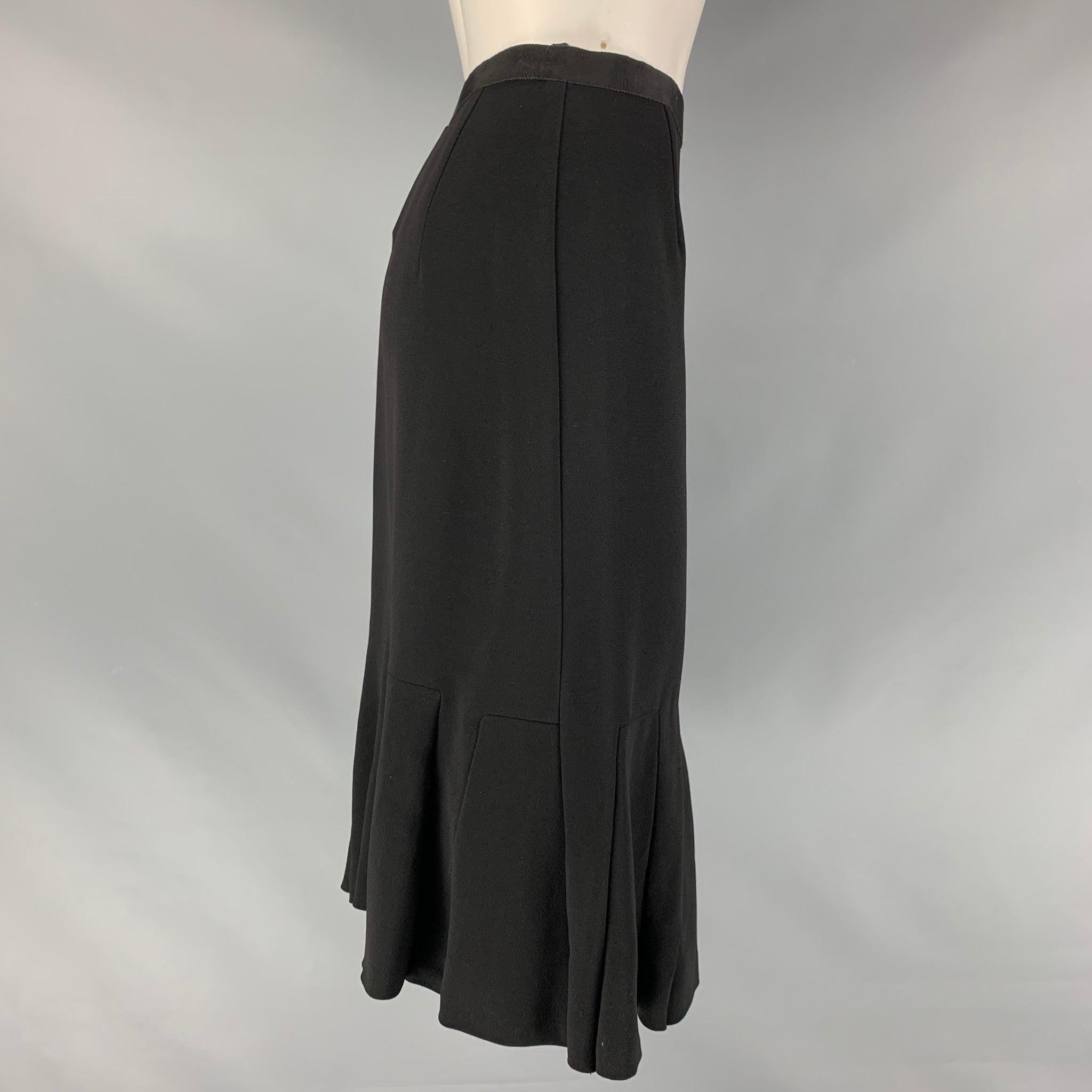 PRADA tulip skirt comes in a black acetate and viscose material featuring a ruffled hem, and a side seam invisible zip up closure. Made in Italy.Good Pre-Owned Condition. Moderate Fading at waistband. As- is. 

Marked:   40 

Measurements: 
  Waist: