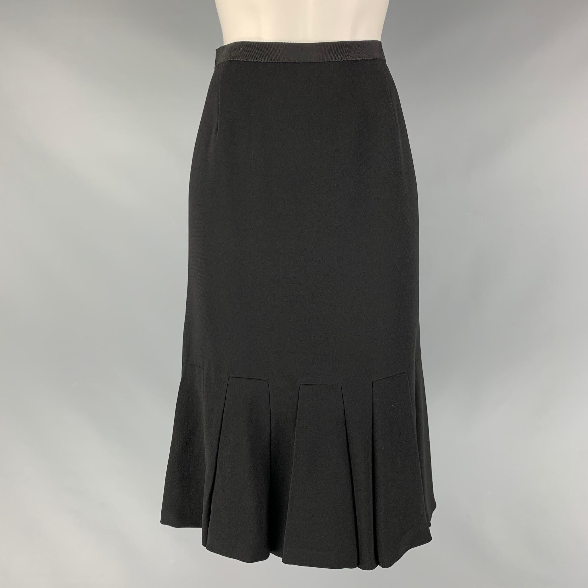 PRADA tulip skirt comes in a black acetate and viscose material featuring a ruffled hem, and a side seam invisible zip up closure. Made in Italy.

Excellent Pre-Owned Condition. Moderate Fading at waistband. As- is.
Marked: 40

Measurements:

Waist: