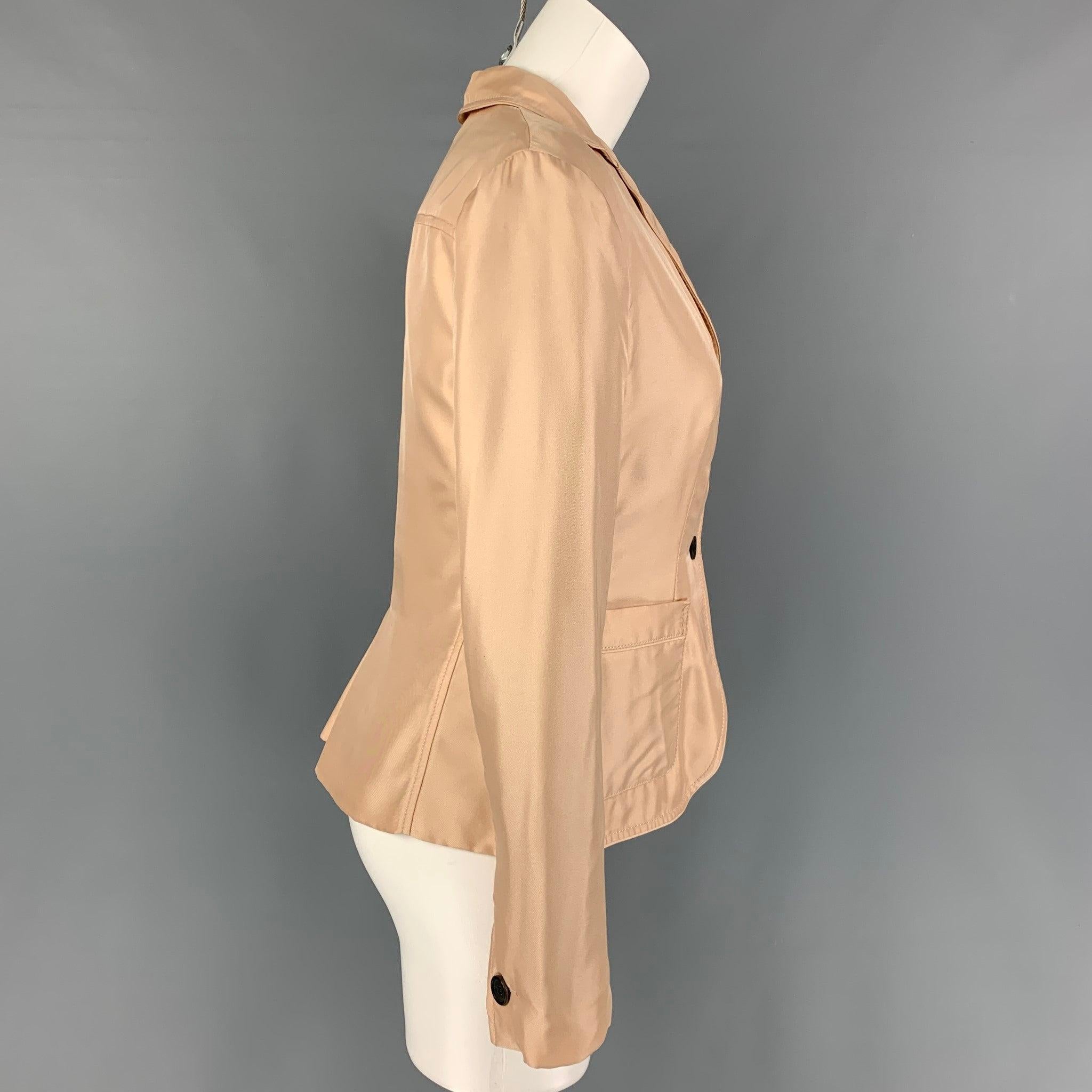 PRADA jacket comes in a blush silk featuring a notch lapel, patch pockets, single back vent, and a three button closure. Made in Italy.
Good
Pre-Owned Condition.
Light marks at back. As-Is.  

Marked:   40 

Measurements: 
 
Shoulder: 16 inches 