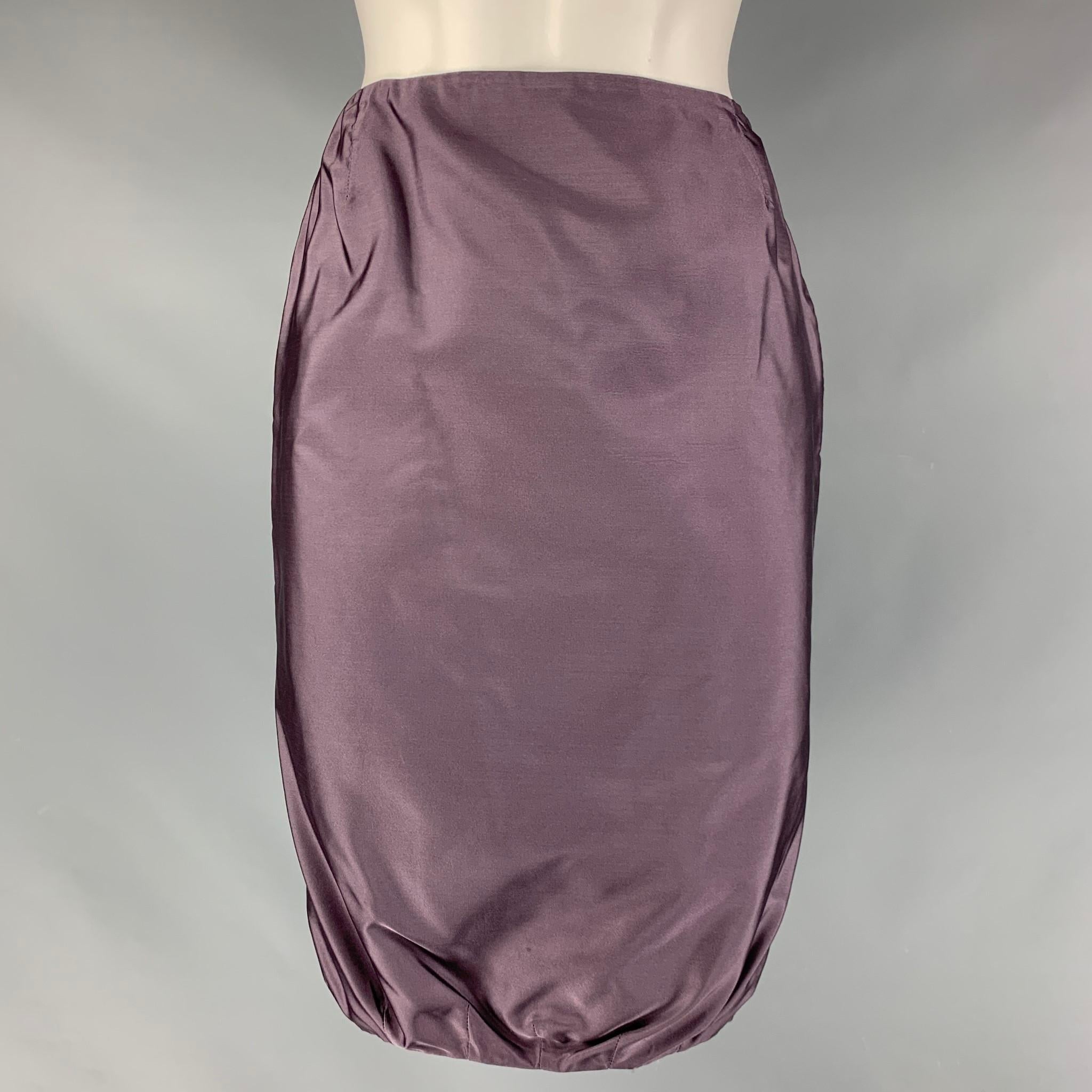 PRADA skirt comes in a lilac silk material featuring a bubble hem, and a side seam zipper closure. Made in Italy.

Excellent Pre-Owned Condition.
Marked: 40

Measurements:

Waist: 24 in.
Hip: 35 in.
Length: 22 in.  
