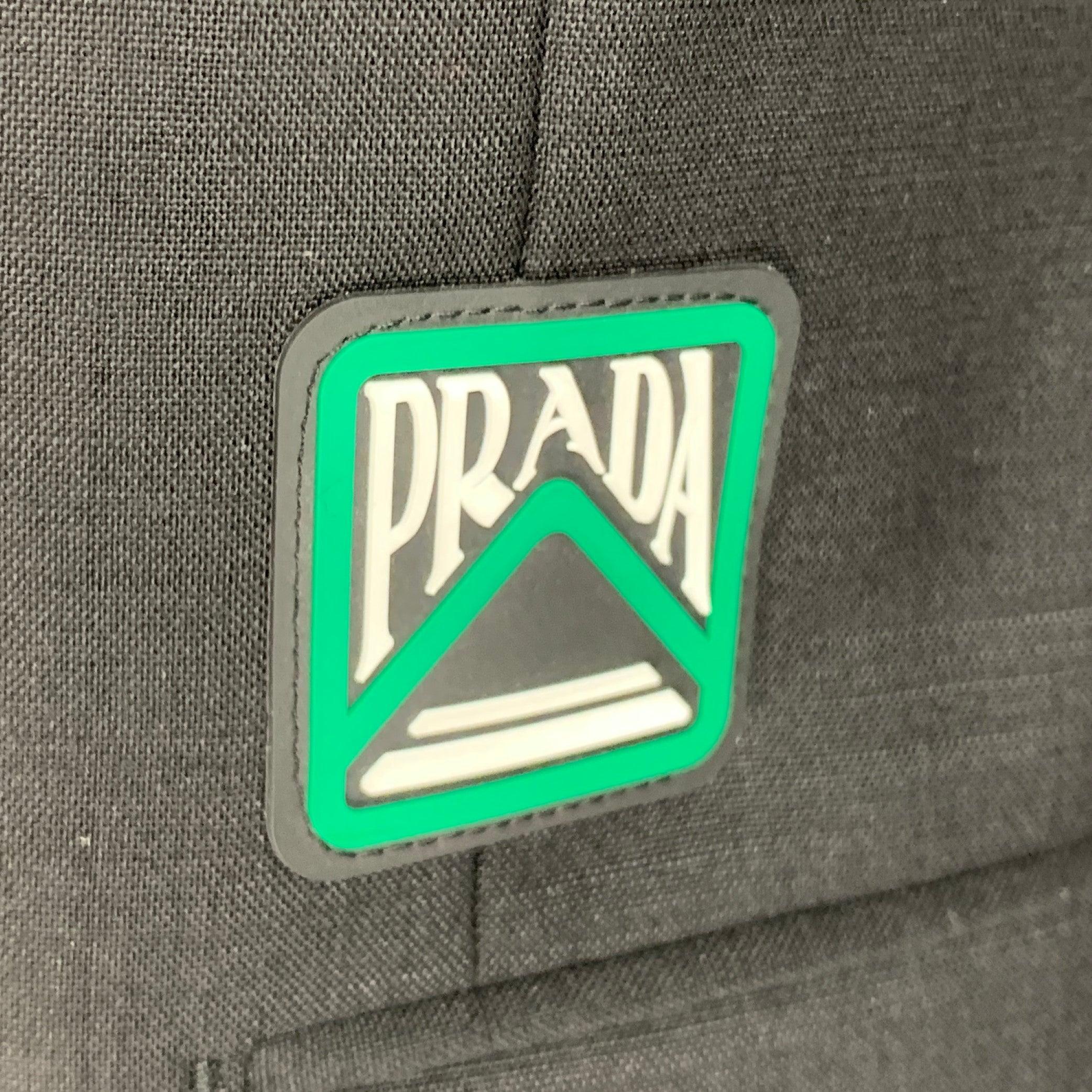 PRADA sport coat
in a black mohair wool blend fabric featuring green rubber logo, notch lapel, single vented back, and double button closure. Made in Italy.Excellent Pre-Owned Condition. 

Marked:   IT 50 

Measurements: 
 
Shoulder: 18 inches