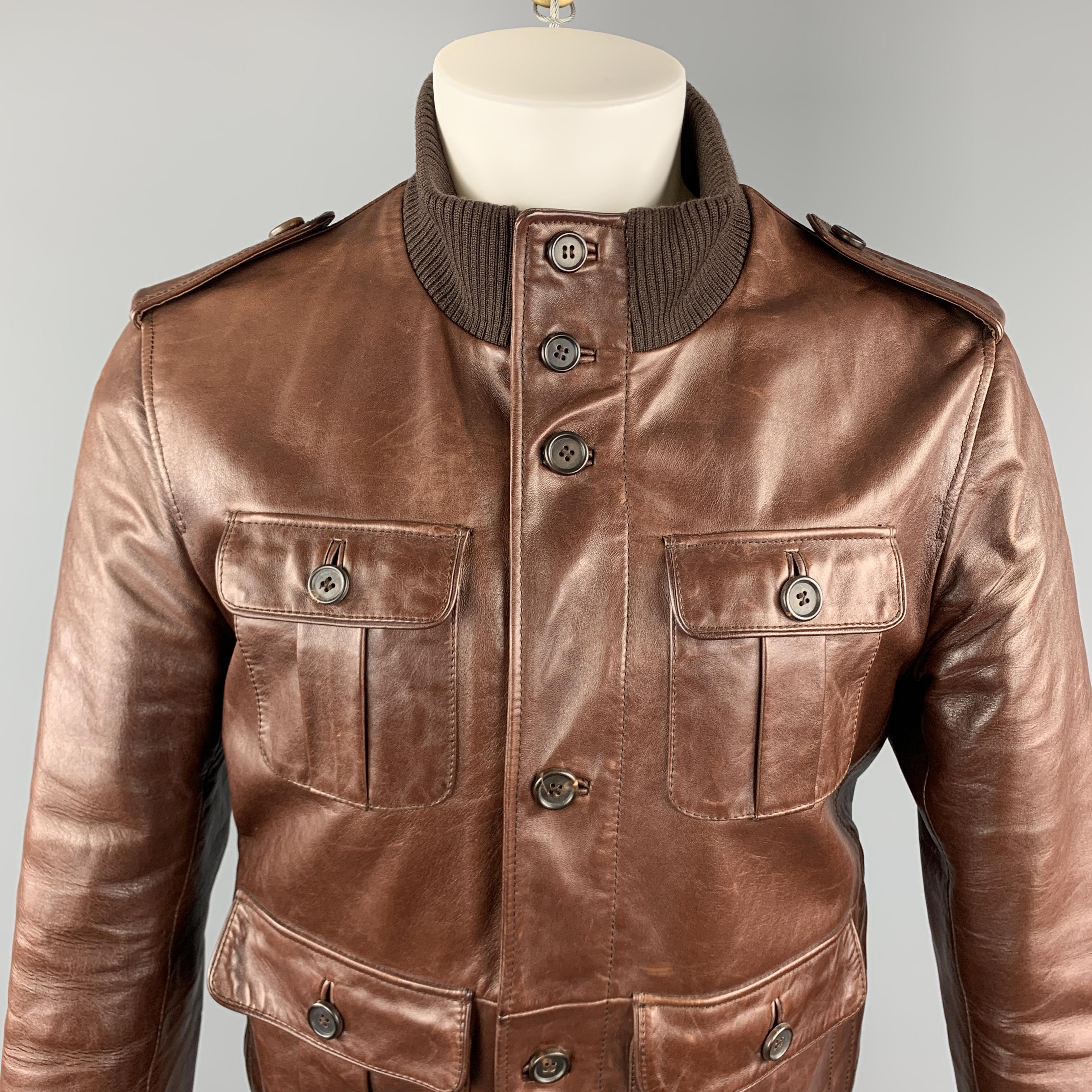 PRADA Jacket comes in a brown solid leather material, with a high collar, single breasted, zip and seven buttons at closure, patch pockets, and ribbed collar, cuffs and hem. Made in Italy.

Excellent Pre-Owned Condition.
Marked: It