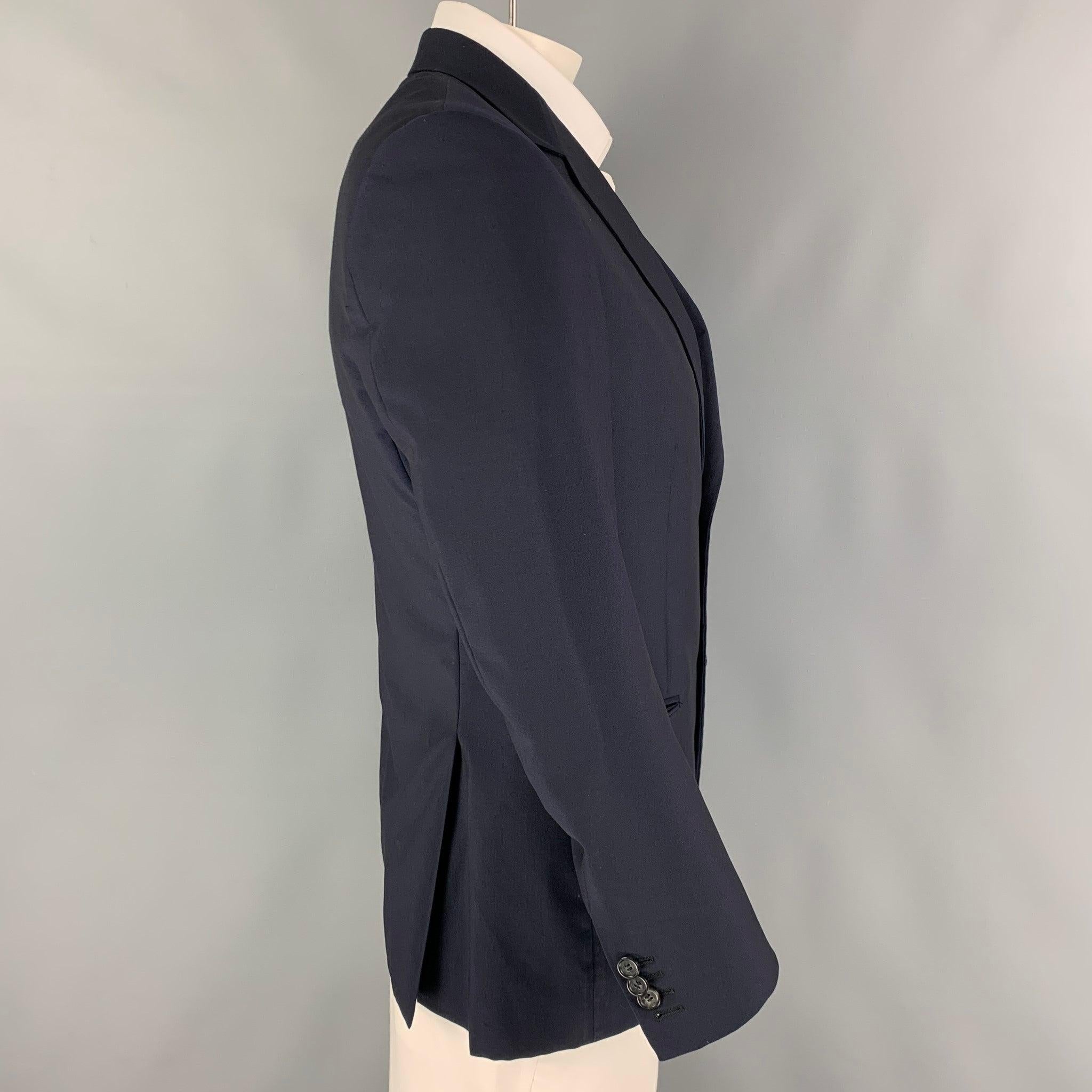 PRADA sport coat comes in a navy / wool with a full liner featuring a notch lapel, flap pockets, double back vent, and a double button closure.
Excellent
Pre-Owned Condition. 

Marked:   52 

Measurements: 
 
Shoulder: 18 inches Chest: 40 inches