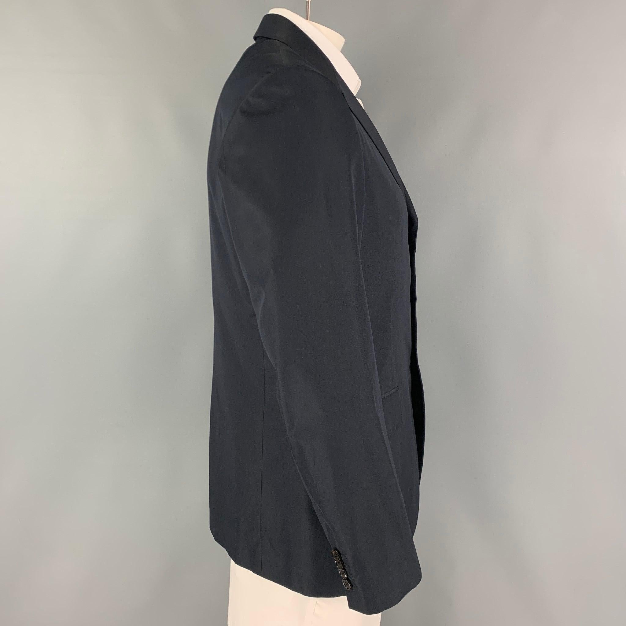 PRADA sport coat comes in a black silk with a full liner featuring a notch lapel, flap pockets, single back vent, and a three button closure. Made in Italy.
Excellent
Pre-Owned Condition. 

Marked:   52 R  

Measurements: 
 
Shoulder: 18 inches