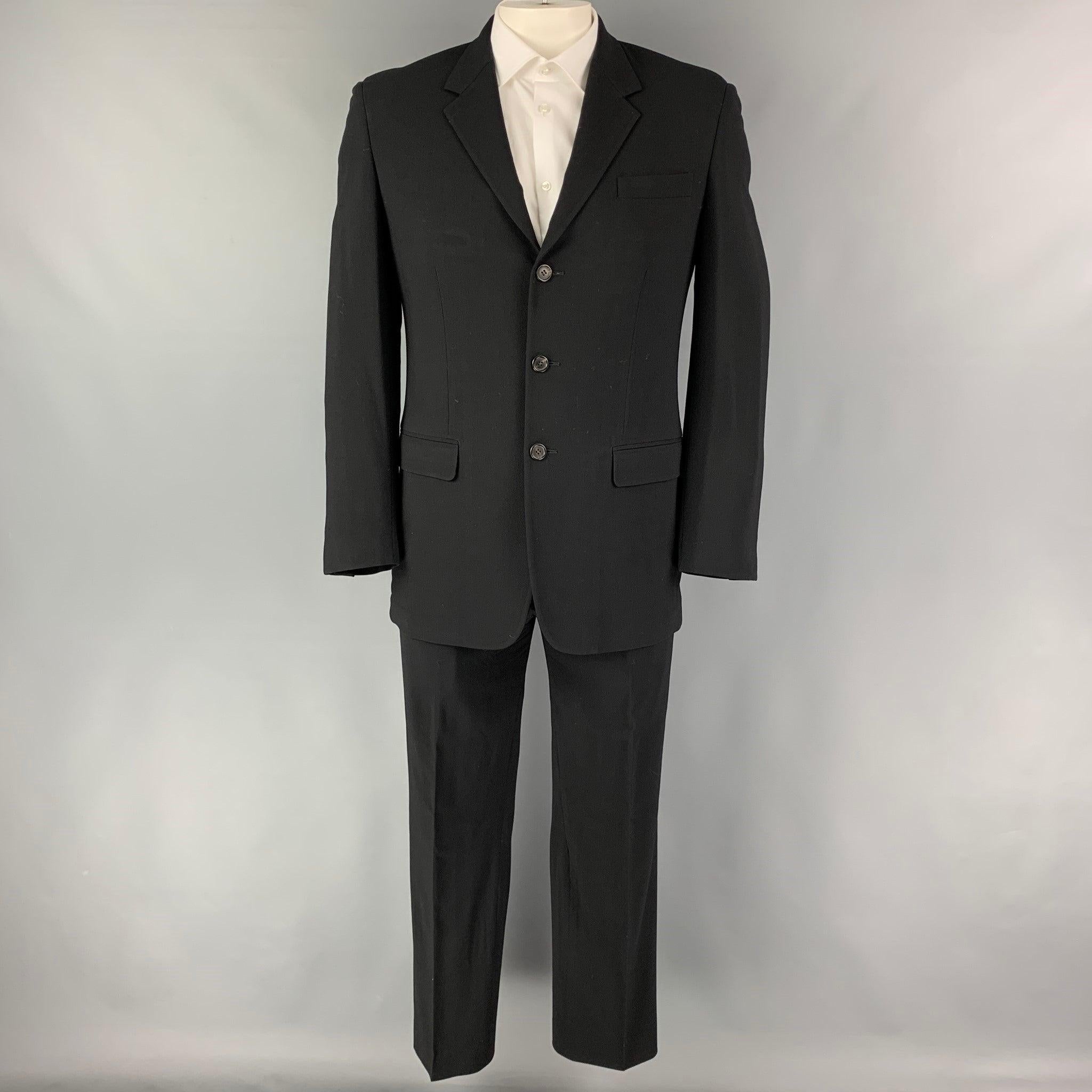 PRADA
suit comes in black virgin wool with a full liner and includes a single breasted, three button sport coat with notch lapel and matching flat front trousers. Made in Italy. Very Good Pre-Owned Condition. 

Marked:   52 

Measurements: 
 