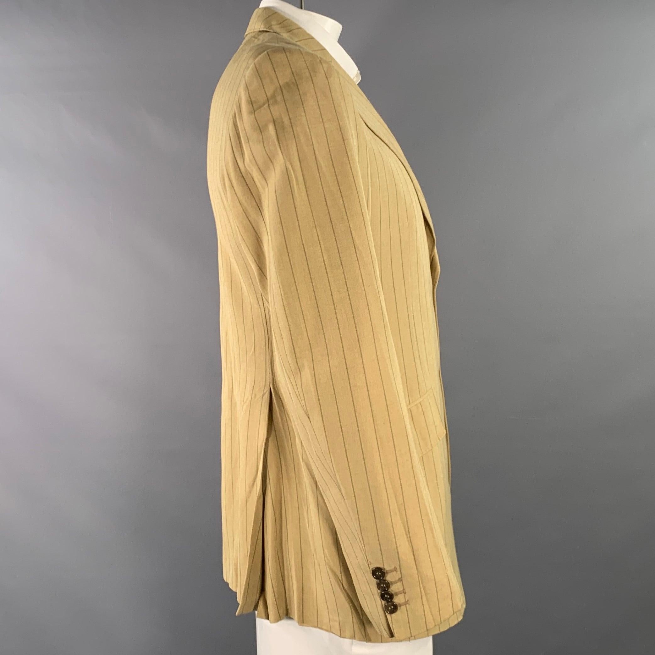 PRADA sport coat
in a tan and brown viscose linen woven blend featuring a pinstripe pattern, notch lapel, double vented back, and double button closure. Made in Italy.Good Pre-Owned Condition. Multiple minor marks. 

Marked:   IT 54R 

Measurements: