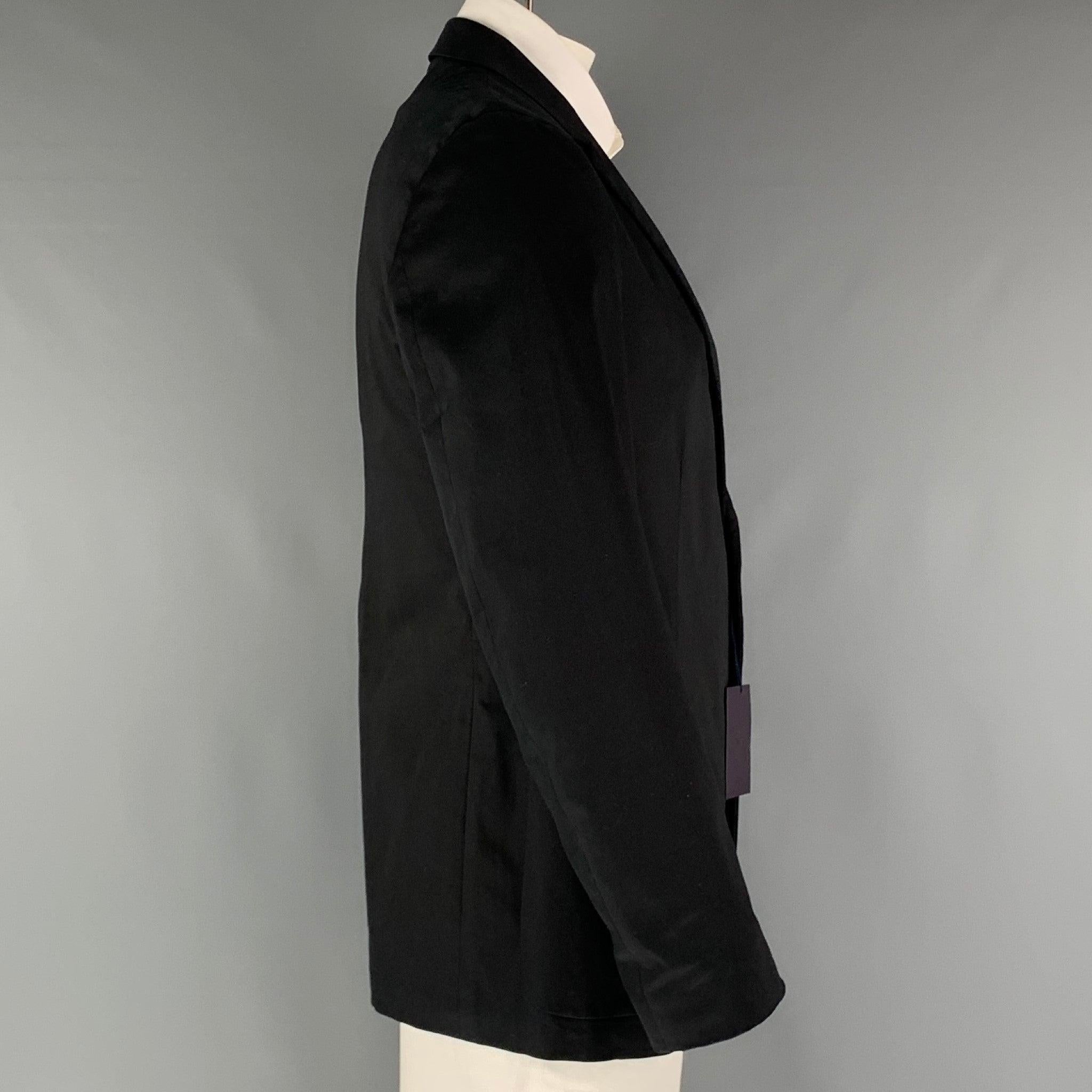 PRADA sport coat comes in a black cotton and elastane woven material with a full liner featuring a notch lapel, patch pockets, single back vent, and a two button closure. Made in Italy.New with Tags. 

Marked:   56 

Measurements: 
 
Shoulder: 18