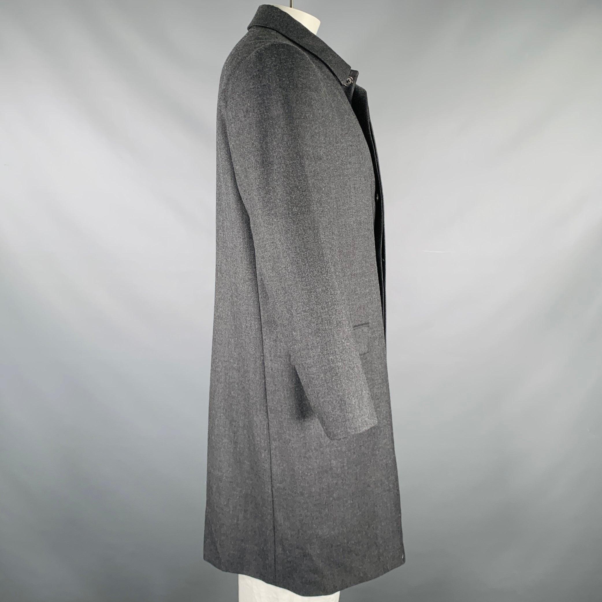 PRADA coat
in a grey wool fabric featuring a long style, two flap pockets, and hidden button closure. Made in Italy.Excellent Pre-Owned Condition. 

Marked:   56 

Measurements: 
 
Shoulder: 17 inches Chest: 47 inches Sleeve: 24.5 inches Length:
