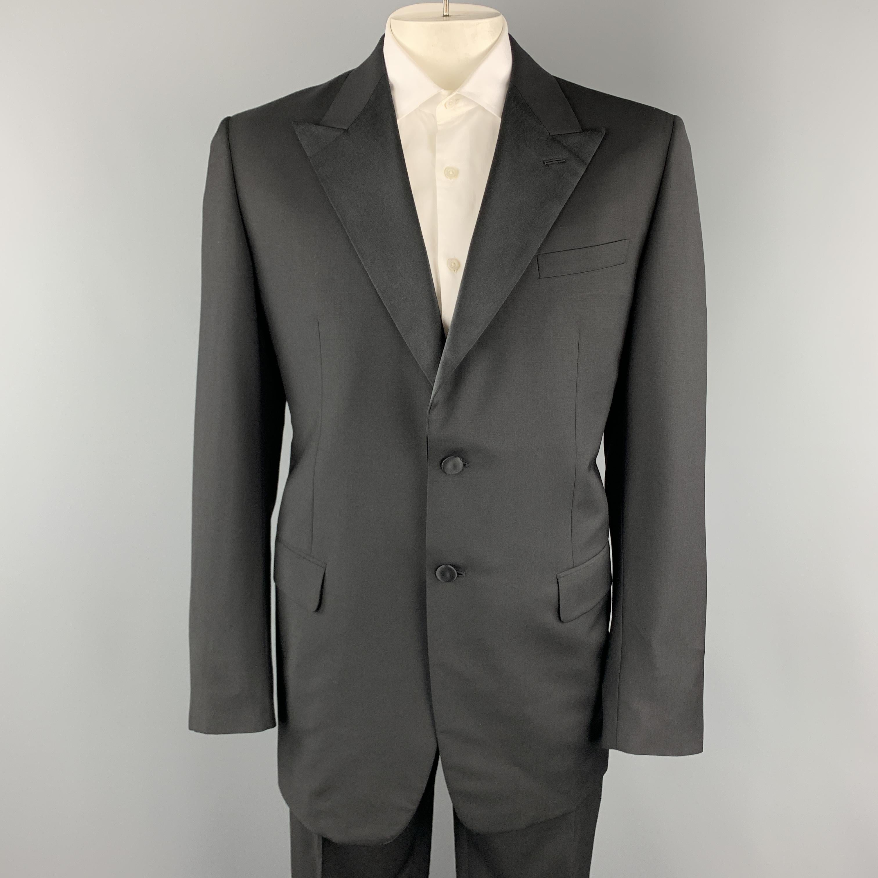PRADA tuxedo suit comes in black virgin wool mohair blend and includes a single breasted, two button sport coat with satin peak lapel and matching flat front satin waistband trousers. Made in Italy.

Excellent Pre-Owned Condition.
Marked: IT