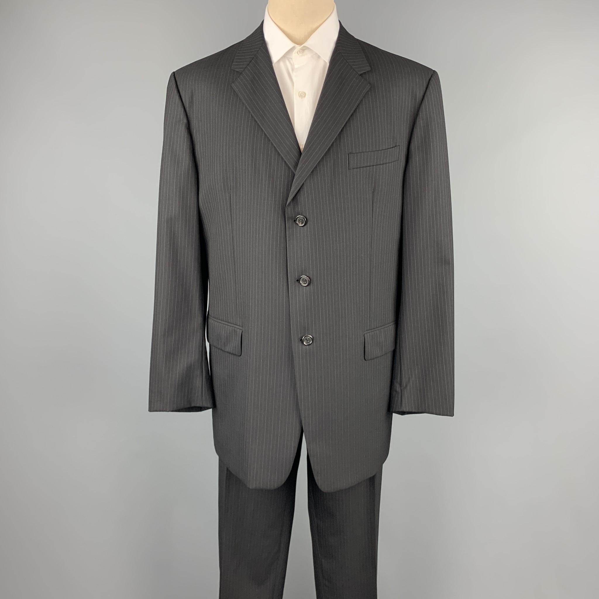 PRADA suit comes in a black stripe wool and includes a single breasted, three button sport coat with notch lapel and matching flat front trousers. Made in Italy.

Excellent Pre-Owned Condition.
Marked: IT 58 L 

Measurements:

-Jacket
Shoulder: 19.5