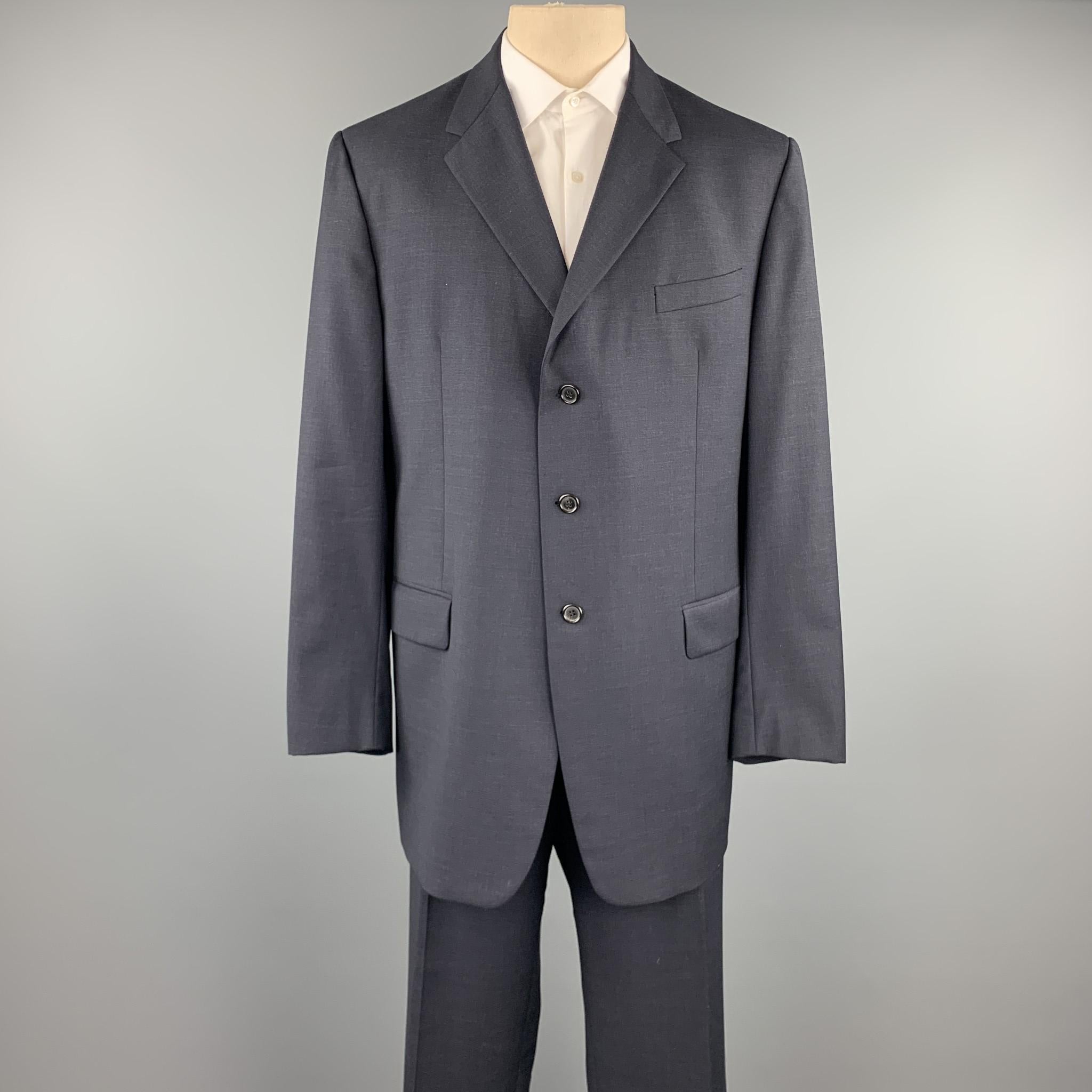 PRADA long suit comes in navy wool and includes a single breasted, three button sport coat with a notch lapel and matching flat front trousers. Made in Italy.

Excellent Pre-Owned Condition.
Marked: IT 58 L
Original Retail Price: