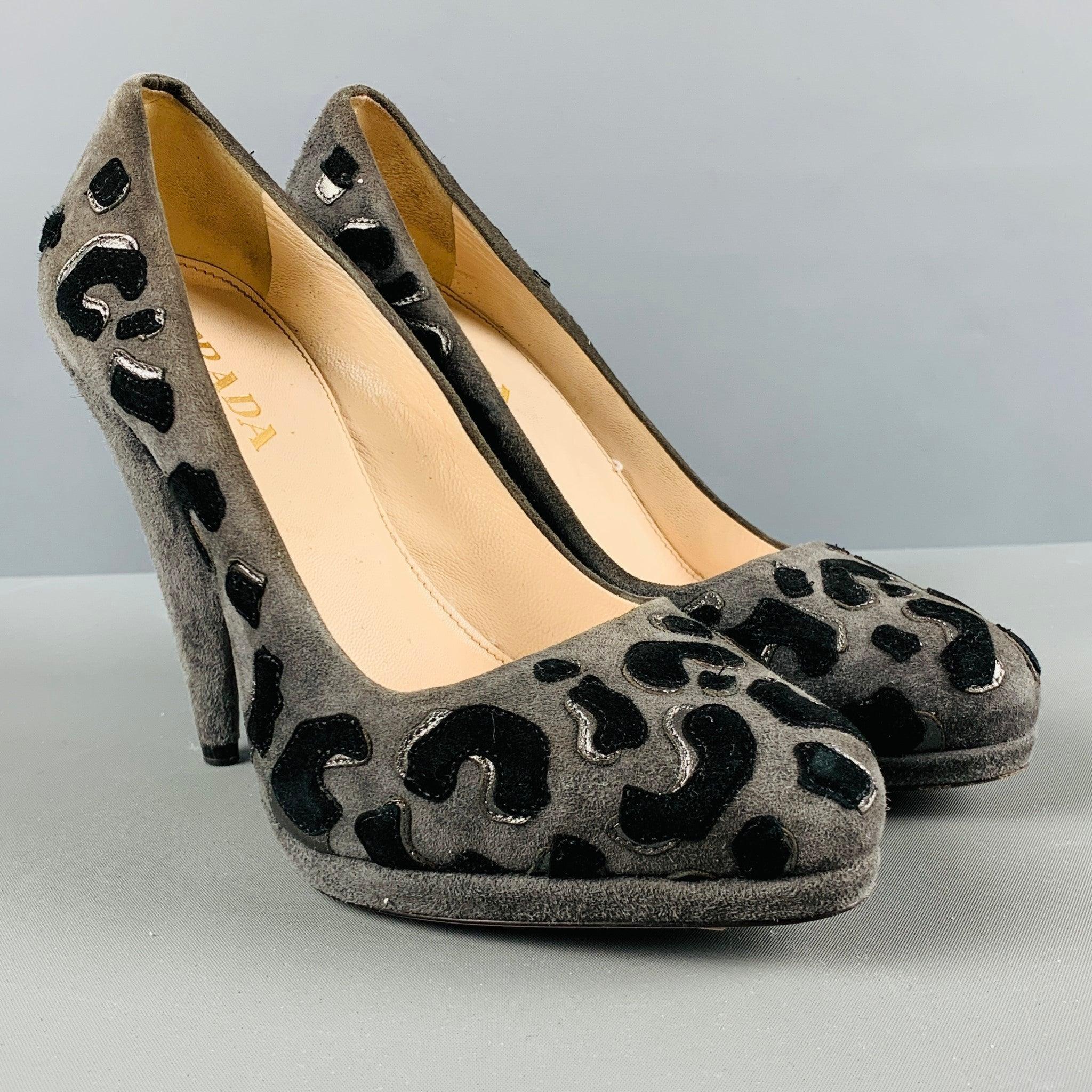 PRADA pumps comes in a black and grey suede featuring leopard applique, platform, and a stacked heel.Comes with dust bag. Made in Italy. Very Good Pre-Owned Condition. 

Marked:   35 

Measurements: 
  Heel: 4.5 inches  
  
  
 
Reference No.: