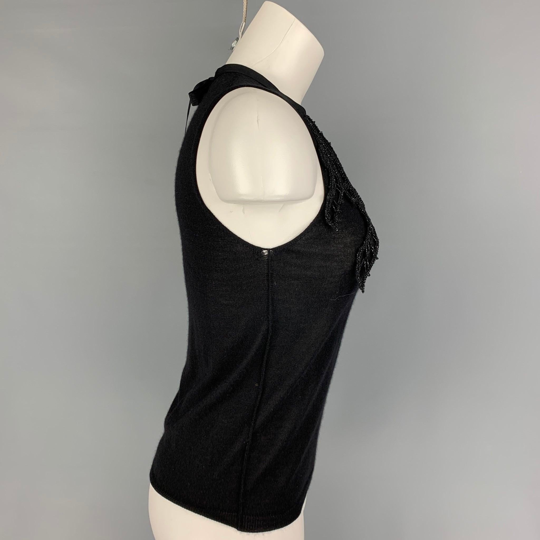 PRADA dress top comes in a black knitted material featuring a front beaded design, self-tie detail, and a sleeveless style. Made in Italy. Very Good
Pre-Owned Condition. 

Marked:   42 

Measurements: 
 
Shoulder: 11.25 inches  Bust: 29 inches 