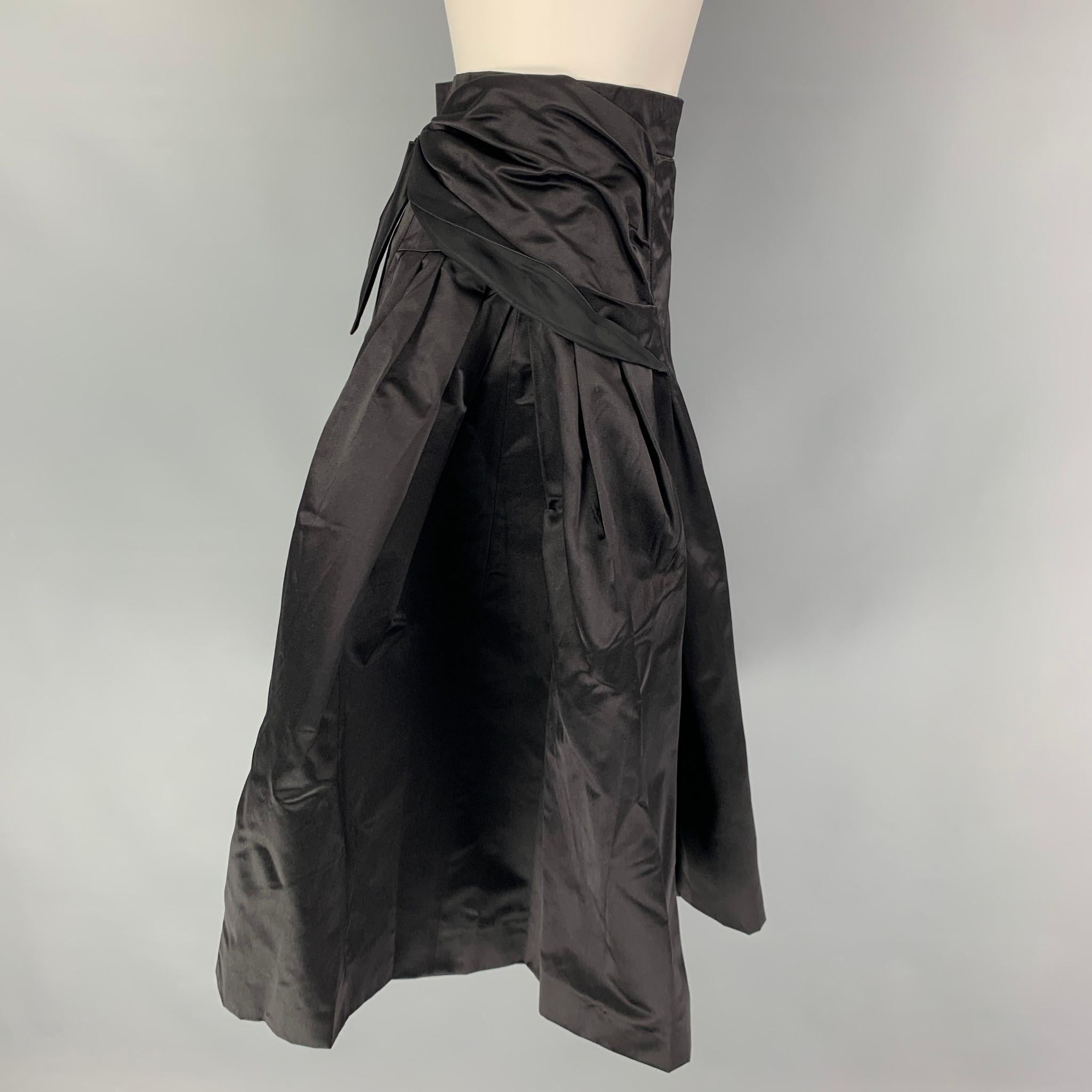 PRADA skirt comes in a black silk featuring an a-line style, detachable bow design, and a side zipper closure. Made in Italy. 

Very Good Pre-Owned Condition.
Marked: 42

Measurements:

Waist: 26 in.
Hip: 34 in.
Length: 27 in.