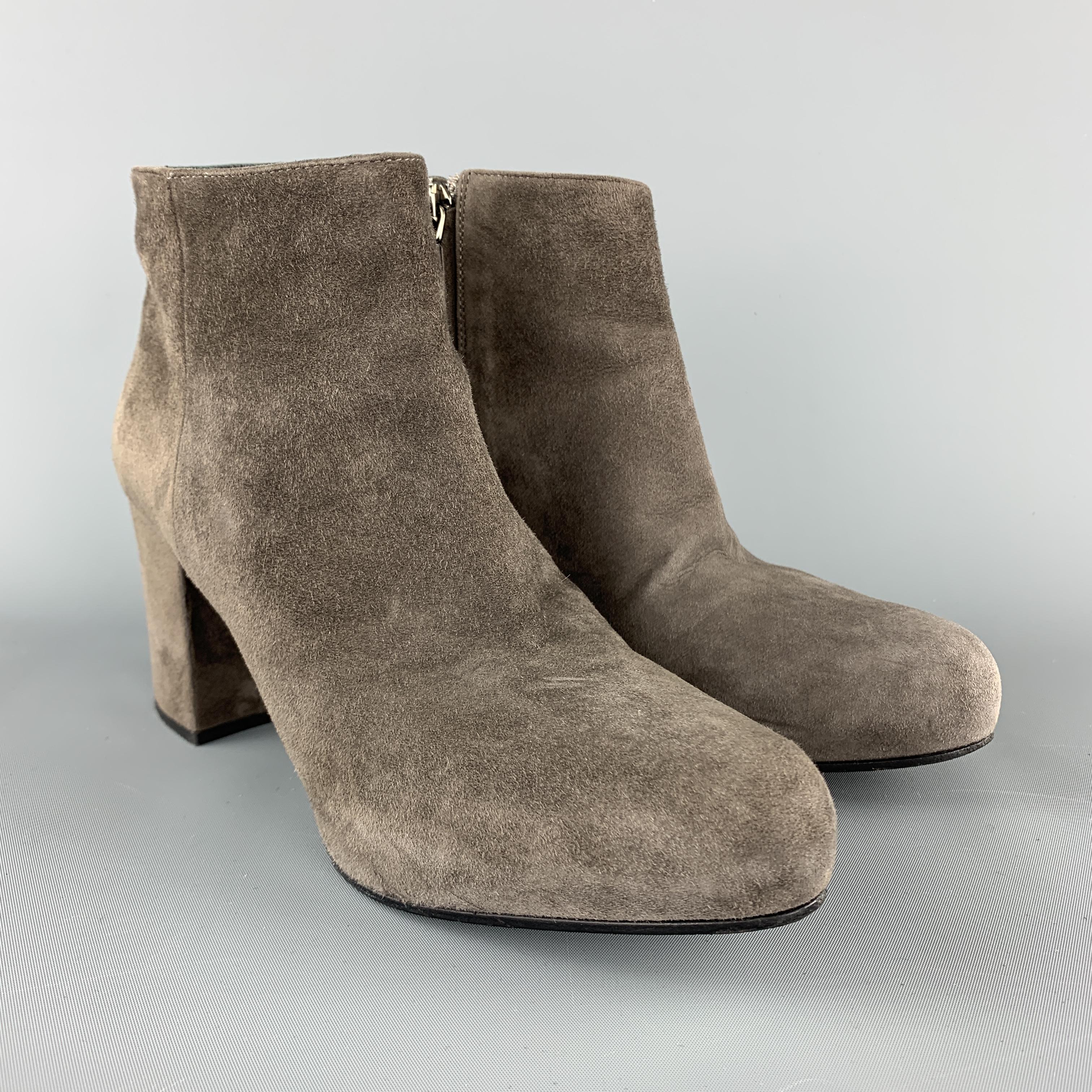 PRADA ankle booties come in grey suede with a hidden platform pointed toe and chunky covered heel. Made in Italy.

Good Pre-Owned Condition.
Marked: IT 36

Measurements:

Heel: 3 in.
Platform: 0.75 in.