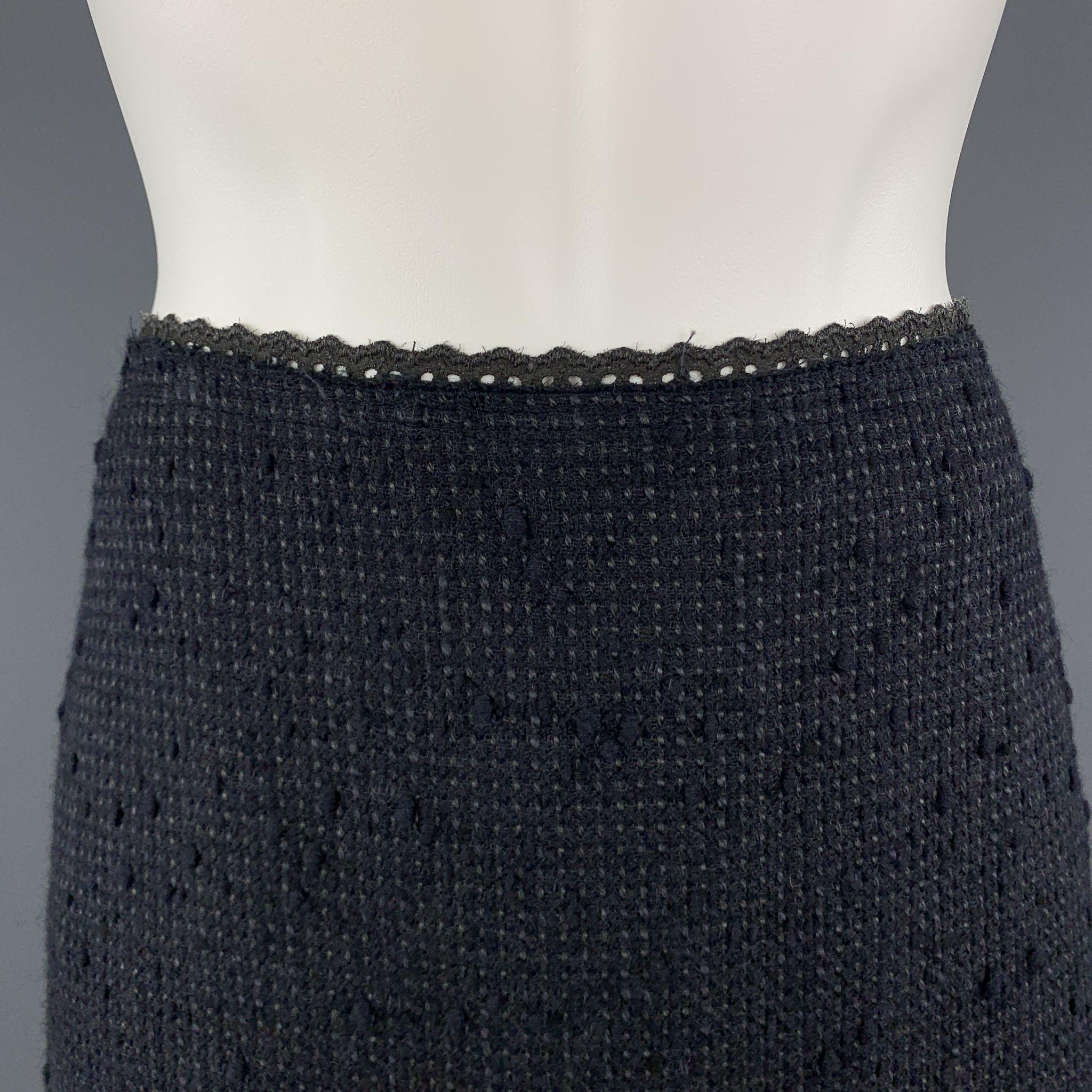 PRADA A line skirt comes in a navy textured tweed with charcoal lace trim. Made in Italy.Excellent
Pre-Owned Condition. 

Marked:   IT 42 

Measurements: 
  Waist: 31 inches Hip:
38 inches Length: 23 inches 
  
  
 
Reference: 105373
Category:
