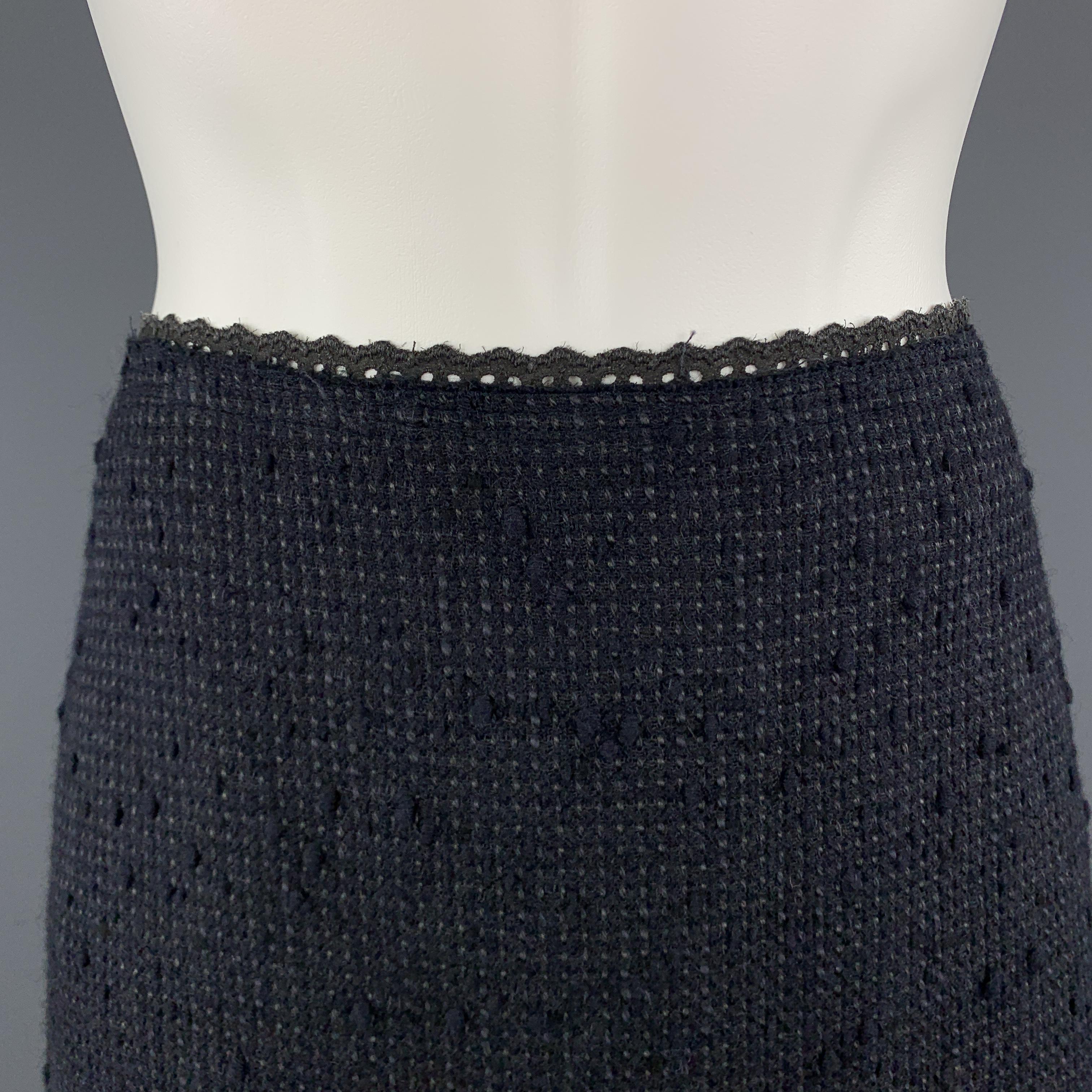 PRADA A line skirt comes in a navy textured tweed with charcoal lace trim. Made in Italy.

Excellent Pre-Owned Condition.
Marked: IT 42

Measurements:

Waist: 31 in.
Hip: 38 in.
Length: 23 in. 