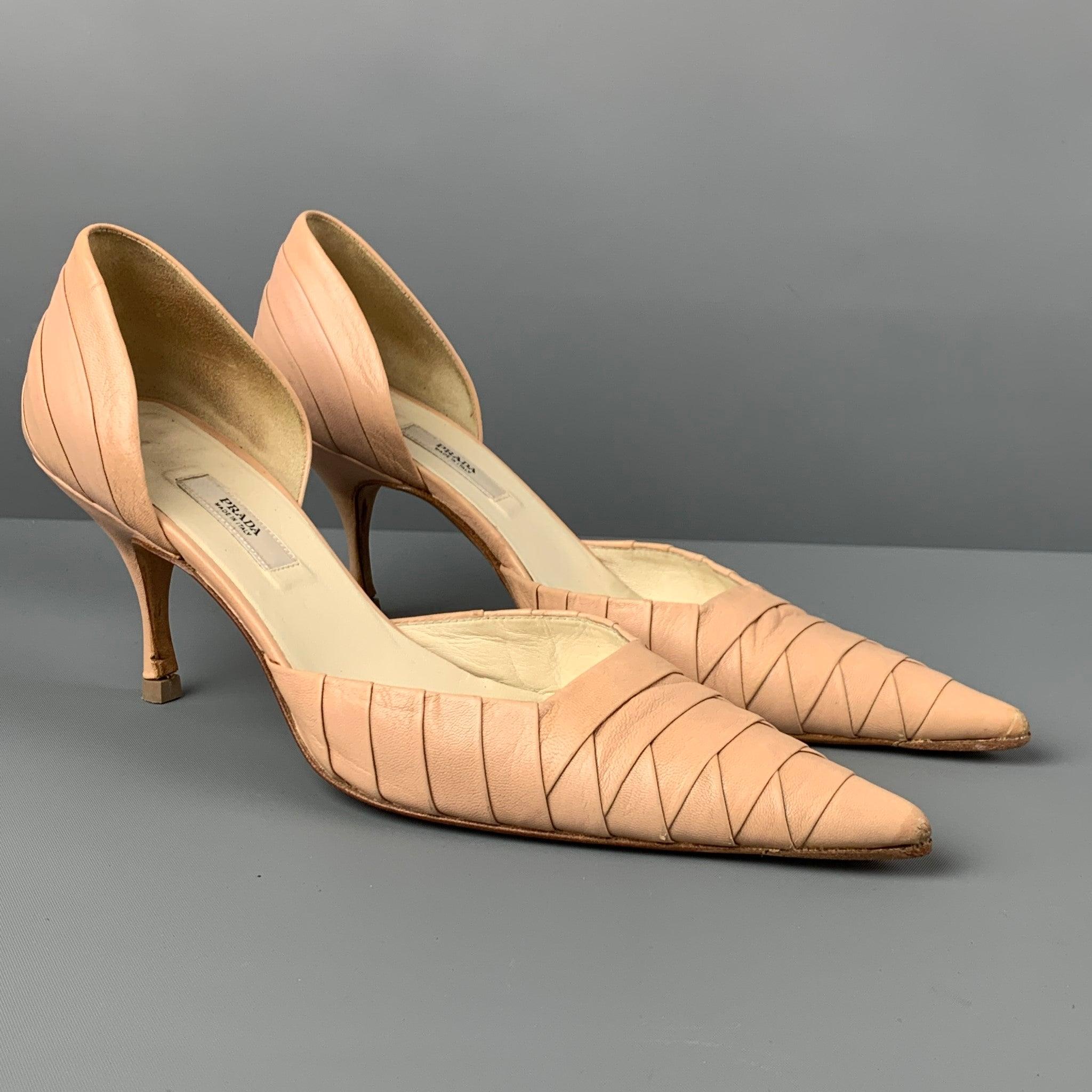 PRADA pumps comes in a nude textured leather featuring a pointed toe, d'orsay style, and a stiletto heel. Made in Italy.
 Good
 Pre-Owned Condition. Light wear. As-Is.  
 

 Marked:  36 
 

 Measurements: 
  Heel: 3 inches 
  
  
  
 Sui Generis