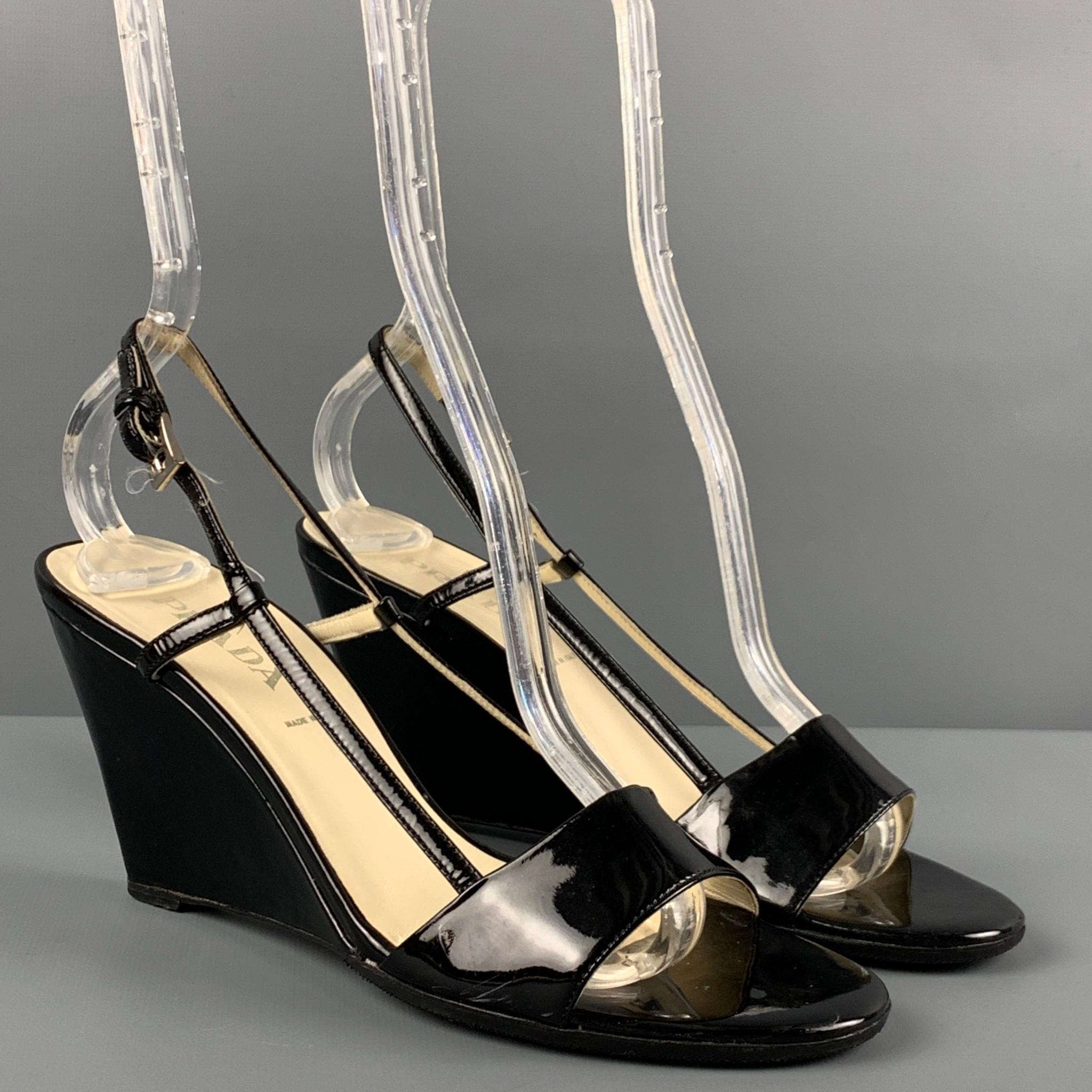 PRADA wedges comes in a black patent leather featuring a open toe, slingback closure, and a wedge heel. Made in Italy. 

Very Good Pre-Owned Condition.
Marked: 36.5

Measurements:

Heel: 3.25 in. 