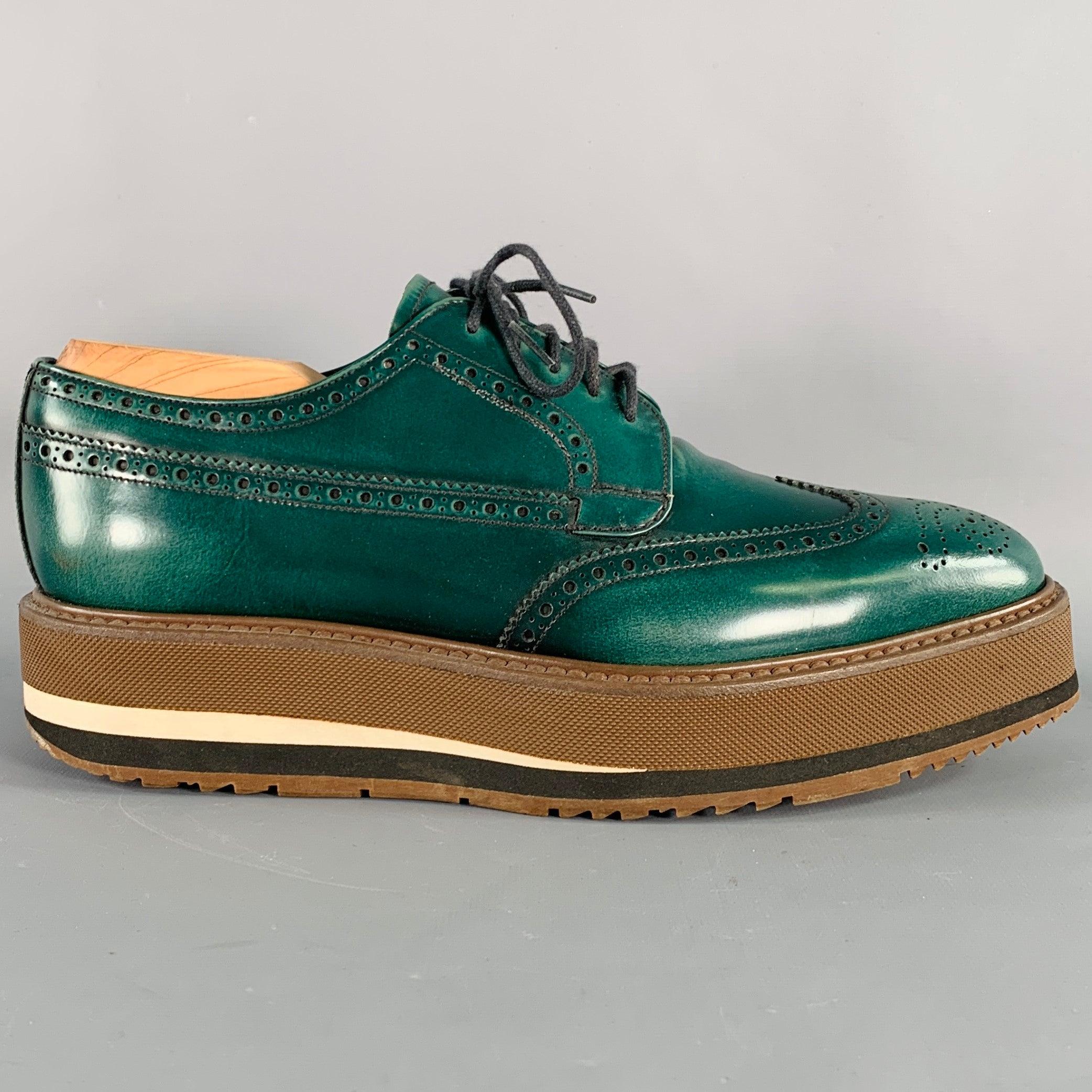 PRADA shoes
in a green leather featuring a platform rubber sole, derby style, and lace-up closure. Shoe trees not included. Made in Italy.Excellent Pre-Owned Condition. 

Marked:   2EG015 5.5
 

Measurements: 
  Outsole: 11.5 inches  x 4 inches