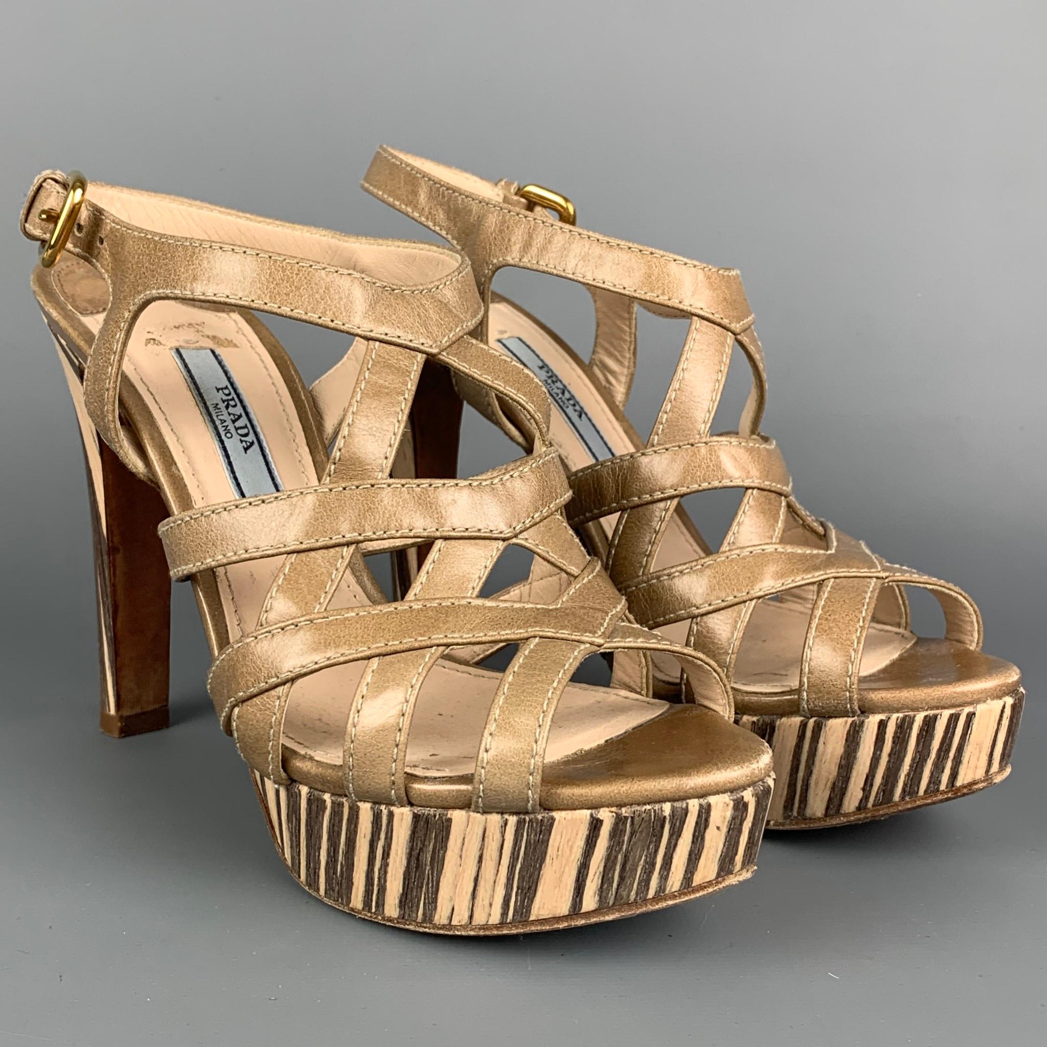 PRADA sandals comes in a taupe & beige with a wood print trim featuring a platform style, criss cross strap, ankle buckle closure, and a chunky heel. Made in Italy. 

Very Good Pre-Owned Condition.
Marked: 36.5

Measurements:

Heel: 4.5 in. 