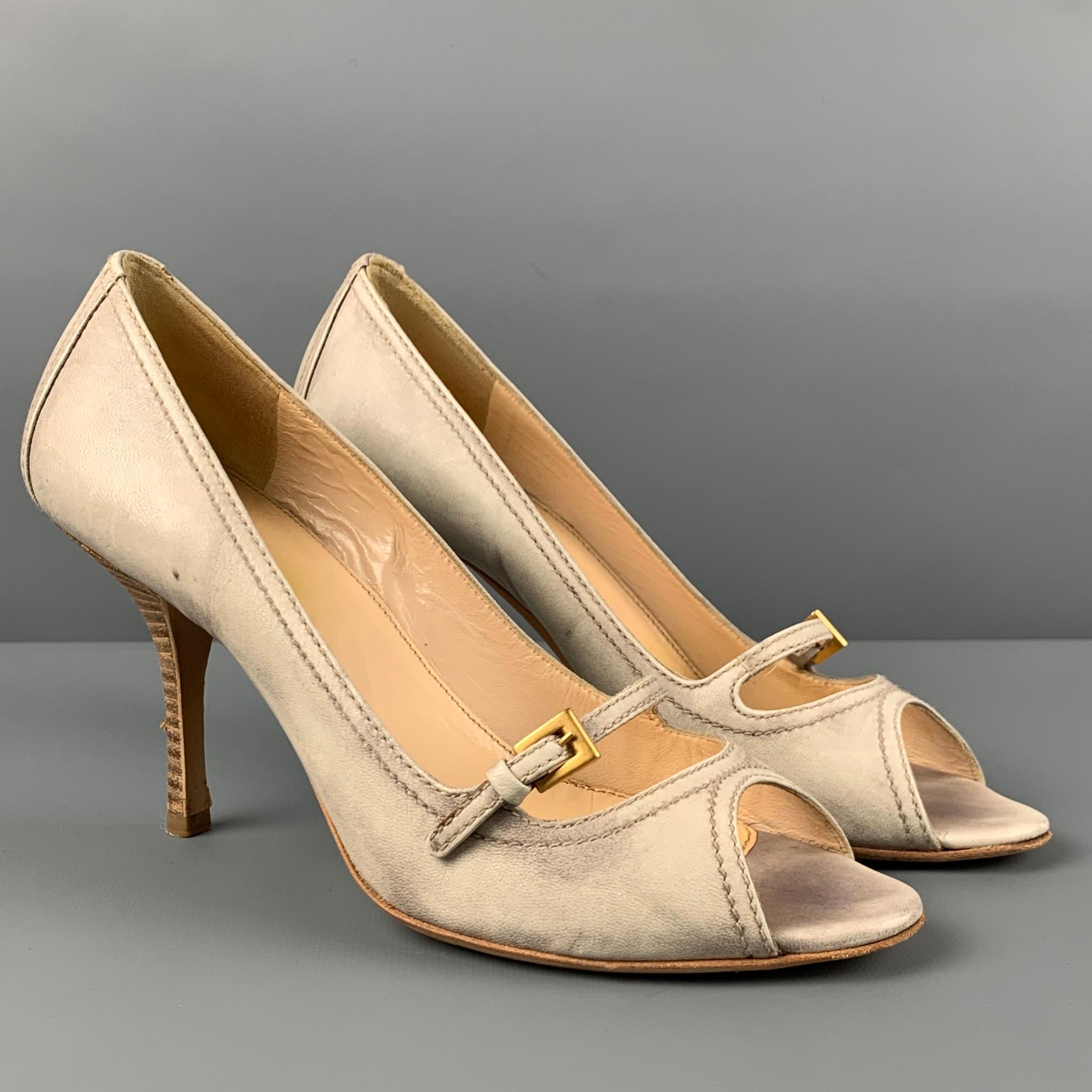 PRADA pumps comes in a beige marbled leather featuring a side buckle detail, open toe, and a stiletto heel. Made in Italy. 

Very Good Pre-Owned Condition.
Marked: 37

Measurements:

Heel: 3.5 in. 