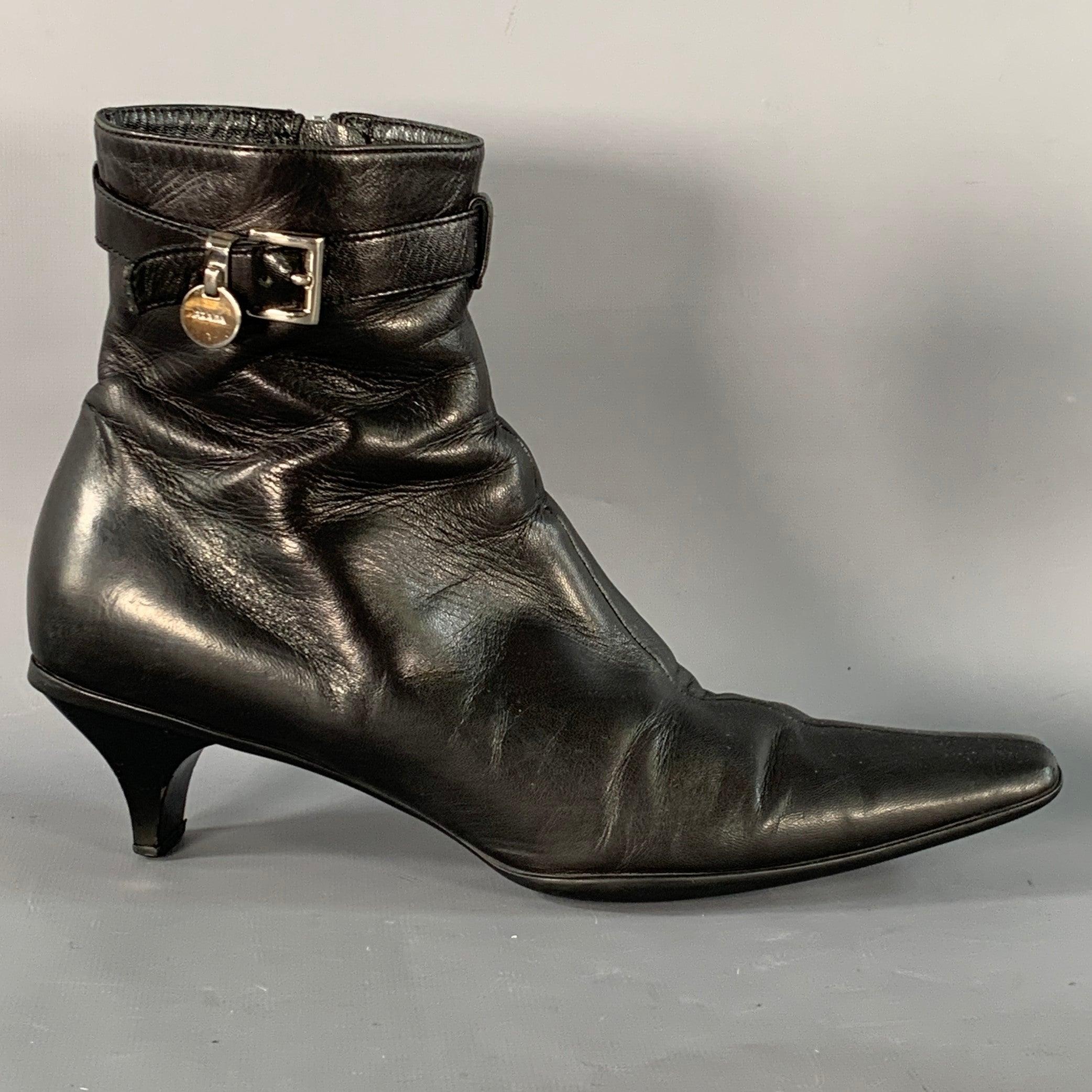 PRADA boots in a black leather featuring an ankle style, kitten heel, and side zipper closure. Made in Italy.Very Good Pre-Owned Condition. Minor signs of wear on trim. 

Marked:   IT 37 

Measurements: 
  Length: 10 inches Width: 3 inches Height