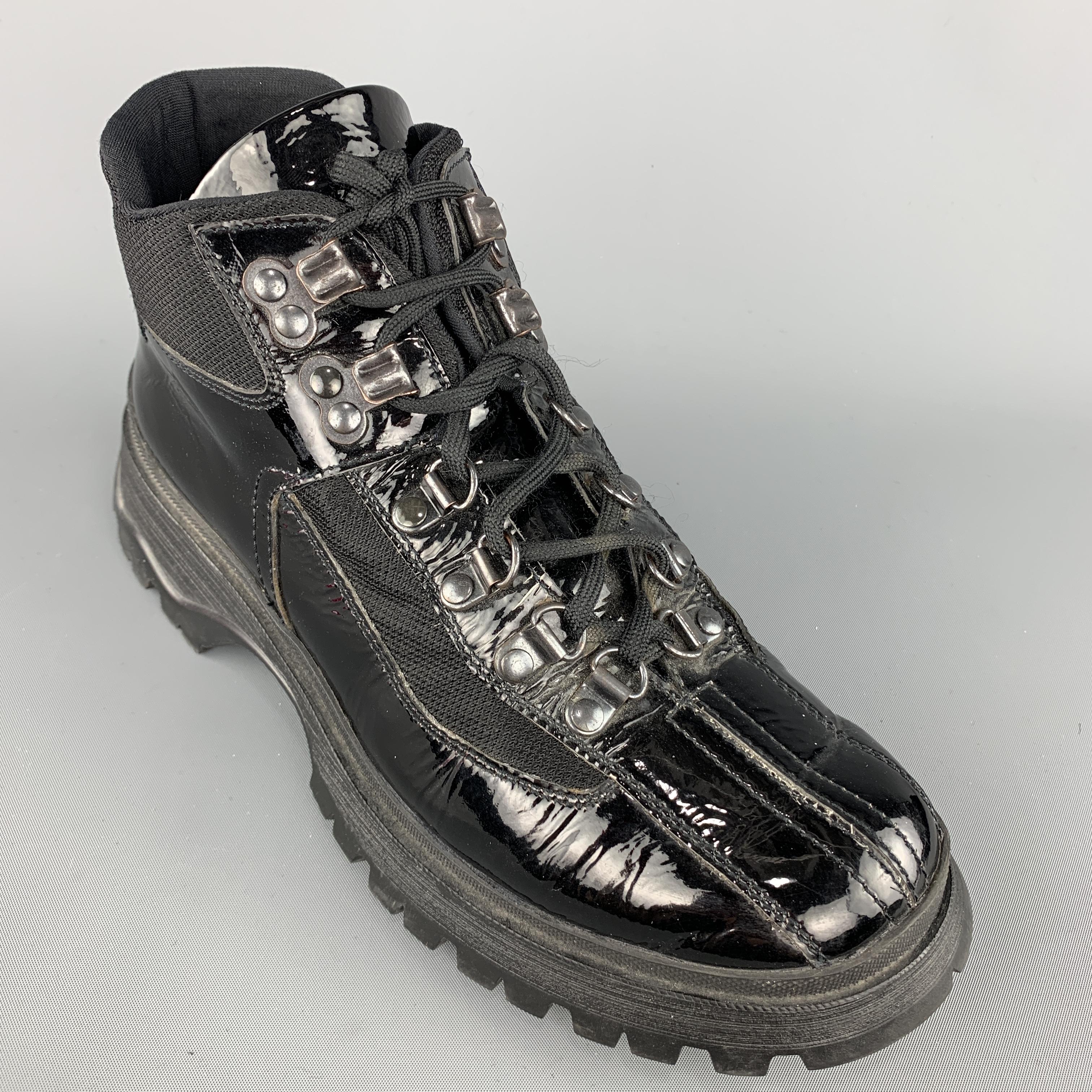 PRADA sneaker ankle boots come in black patent leather with nylon panels, ski hook lace up front, and chunky hiking sole. Made in Italy.
 
Very Good Pre-Owned Condition.
Marked: IT 37
 
Platform Sole: 1 in.