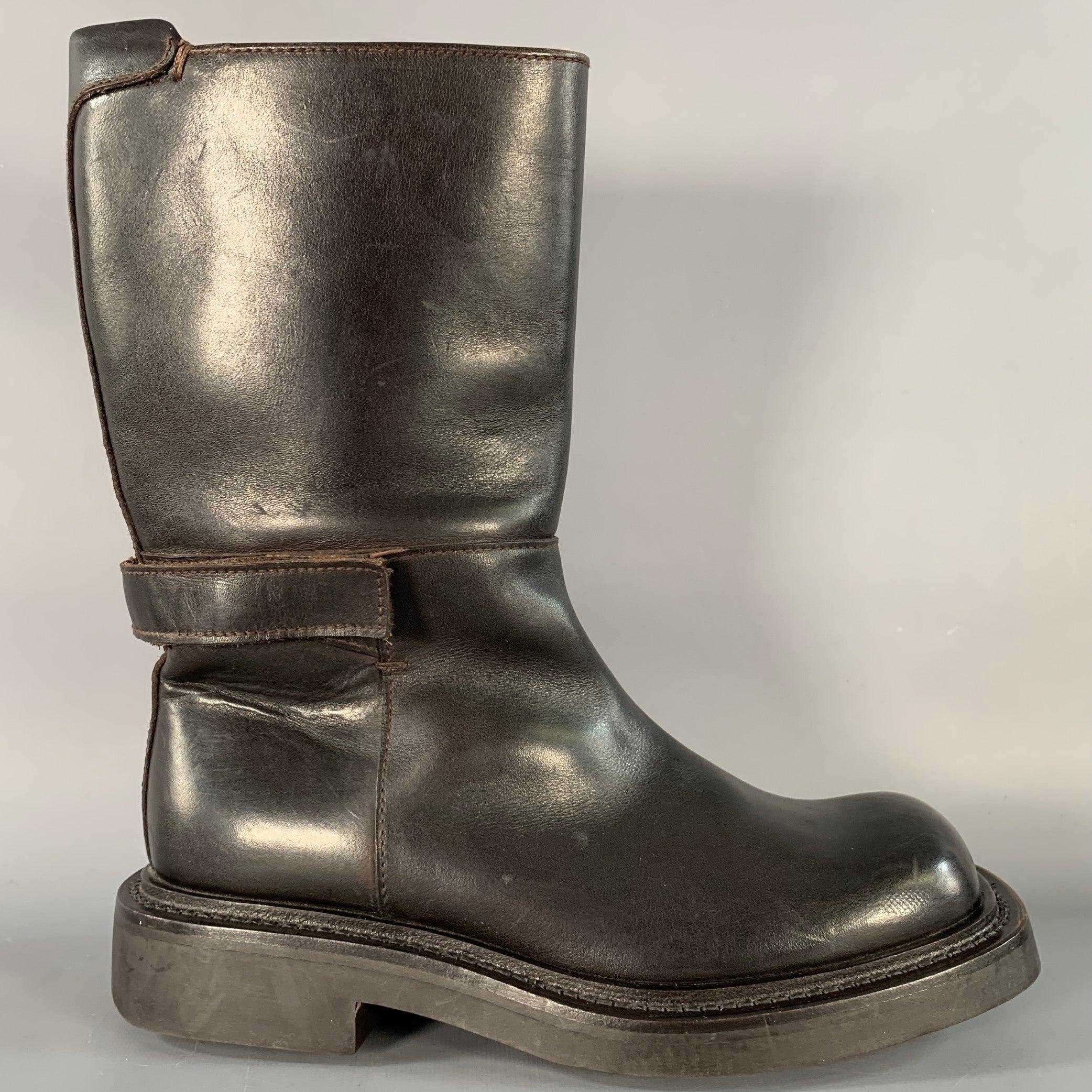 PRADA engineer boots
in a brown leather featuring a calf high style, rubber sole, and hook & loop closure.Very Good Pre-Owned Condition. Signs of wear on toes. 

Marked:   1054 B 99 6 

Measurements: 
  Length: 11.25 inches Width: 4.5 inches Height: