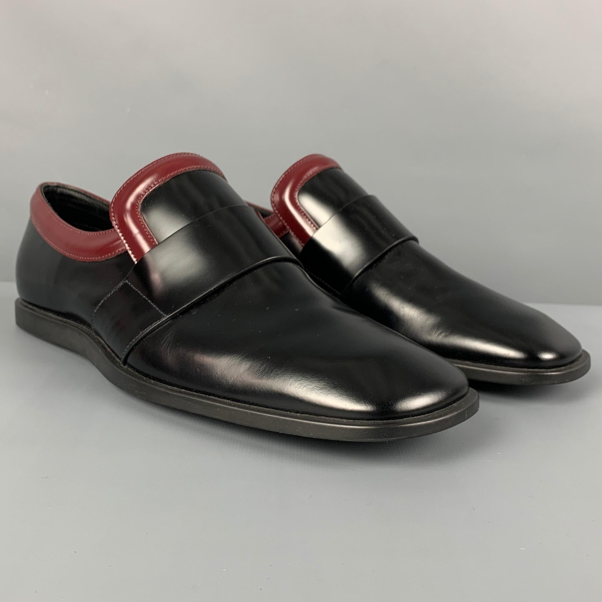 PRADA loafers comes in a black & burgundy two toned leather featuring a square toe and a leather sole. Made in Italy. 

New Without Tags.
Marked: 2 DG 024 7.5
Original Retail Price: $925.00

Outsole: 11.5 in. x 4 in. 