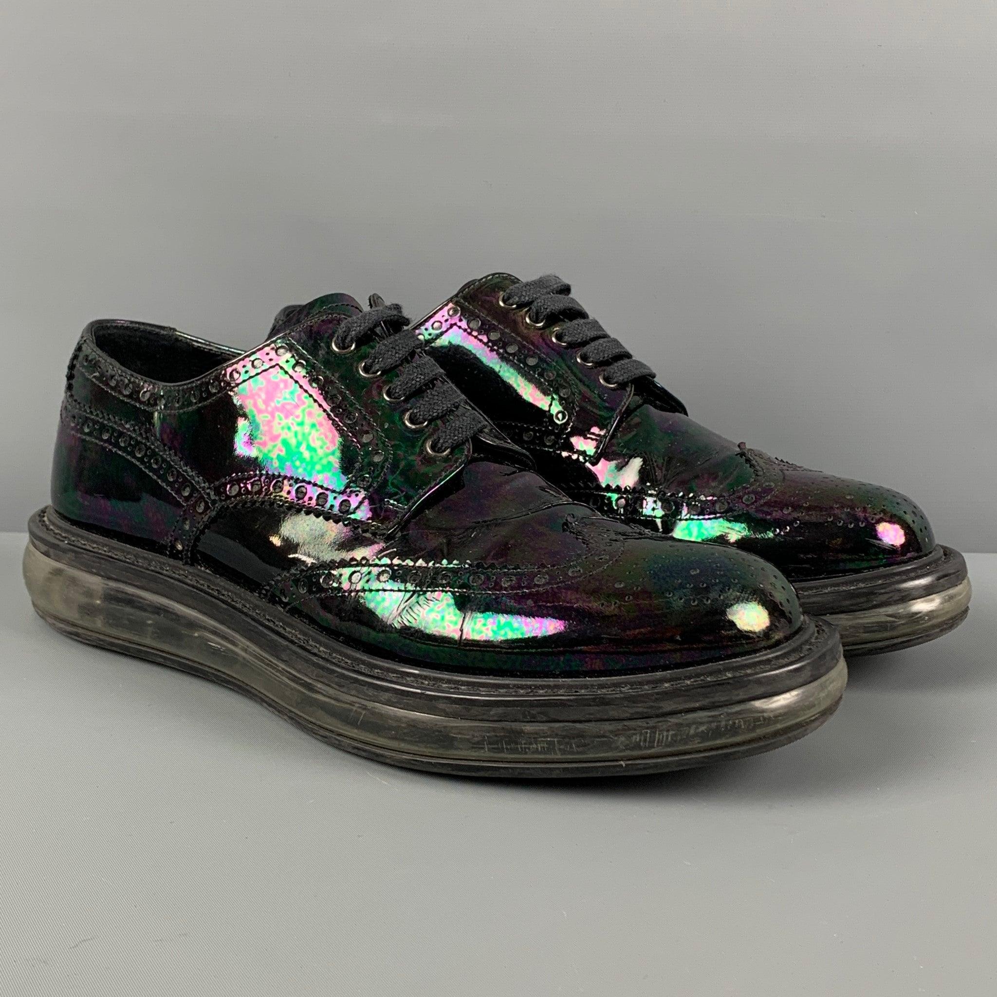 PRADA shoes comes in a black iridescent patent leather featuring a transparent rubber sole and a lace up closure. Made in Italy.
Very Good
Pre-Owned Condition. 

Marked:   2EE 098 6.5Outsole: 12 inches  x 4.5 inches 
  
  
 
Reference: