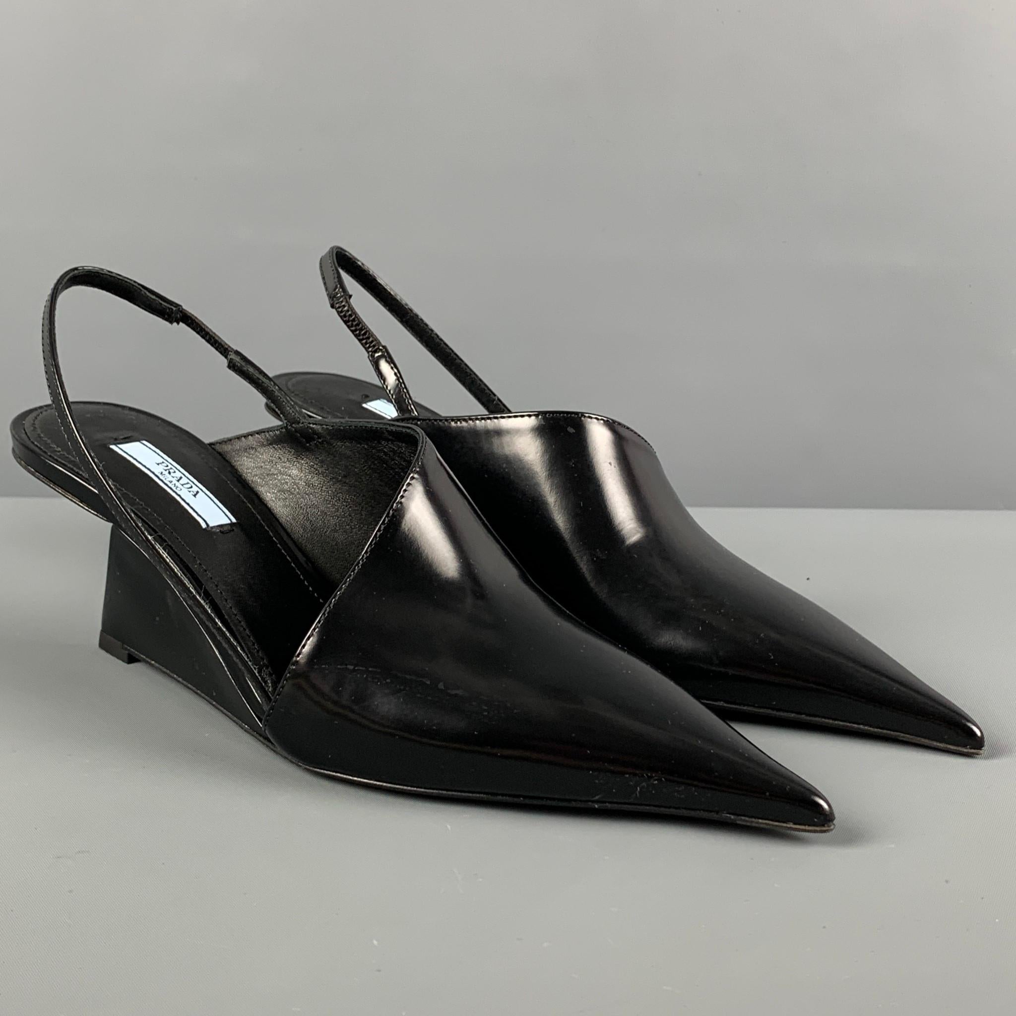 PRADA pumps comes in a black leather featuring a pointed toe, slingback detail, and a wedge heel. Made in Italy. 

New Without Tags.
Marked: 37.5
Original Retail Price: $1,250.00

Measurements:

Heel: 2.25 in. 