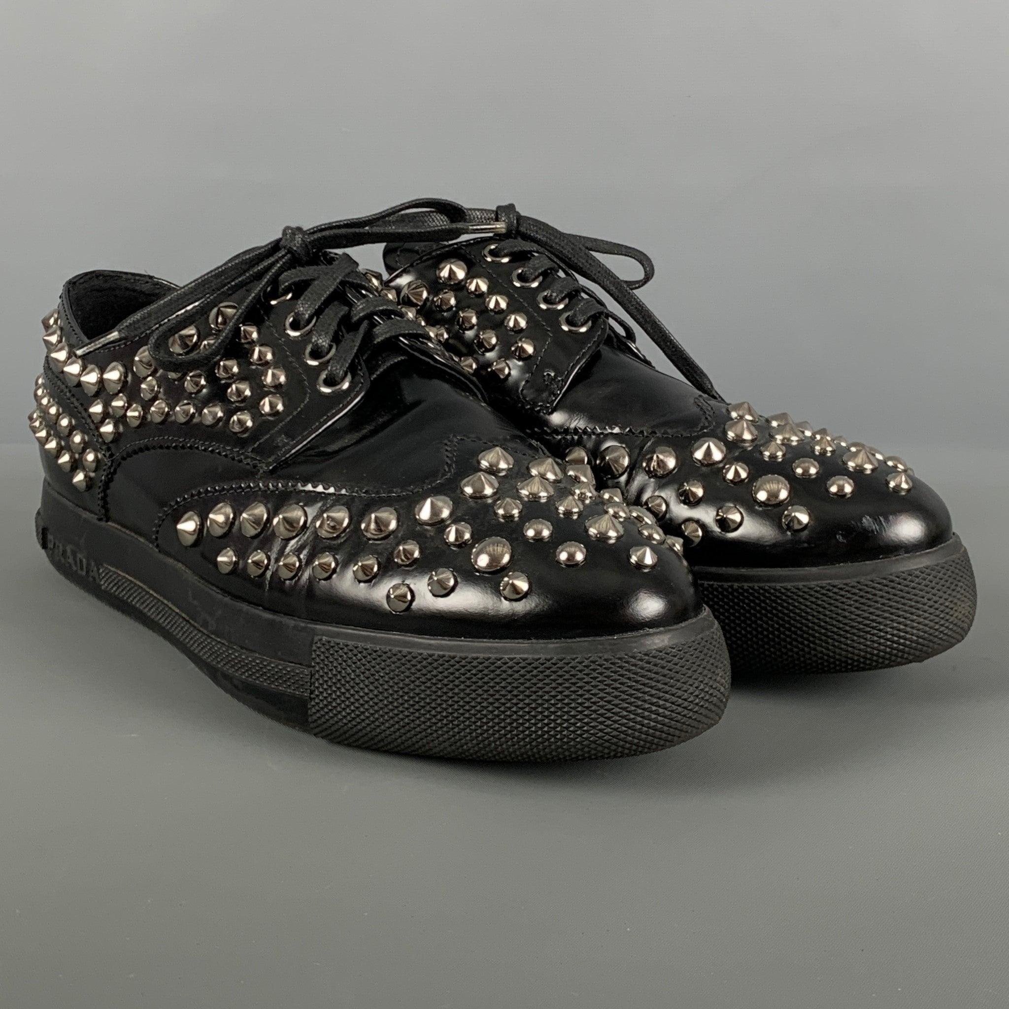 PRADA SPORT shoes comes in a black leather featuring silver tone studded details, and a lace up closure. Very Good Pre-Owned Condition. 

Marked:   3E 5676 37.5Outsole: 10.25 inches  x 3.25 inches 

  
  
 
Reference: 125588
Category: Laces
More