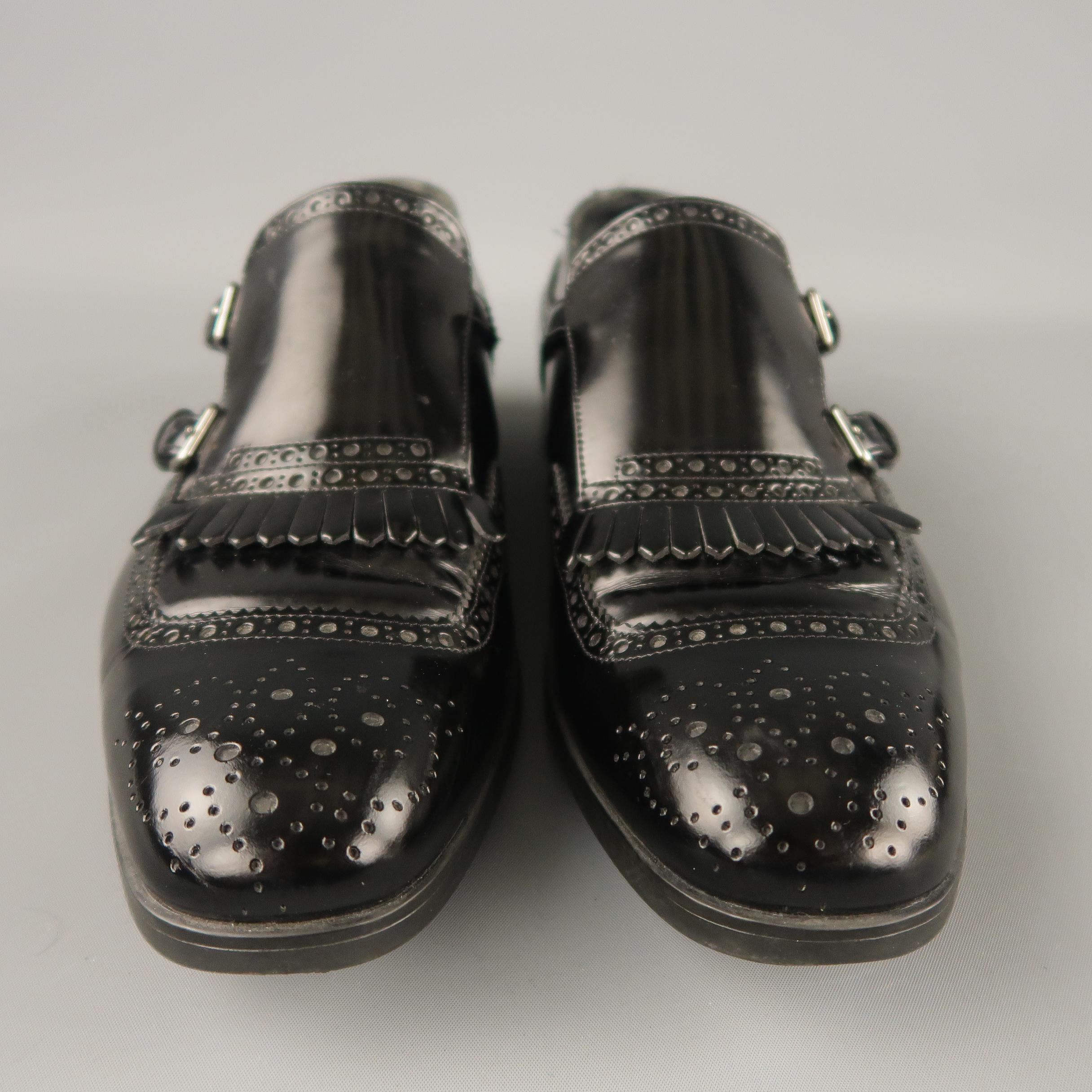 PRADA loafers come in a black leather featuring a double monk strap and a heeled rubber sole. Made in Italy.
 
Excellent Pre-Owned Condition.
Marked: 6.5
 
Measurements:
 
Width: 4.1 in.
Length: 12.6 in.