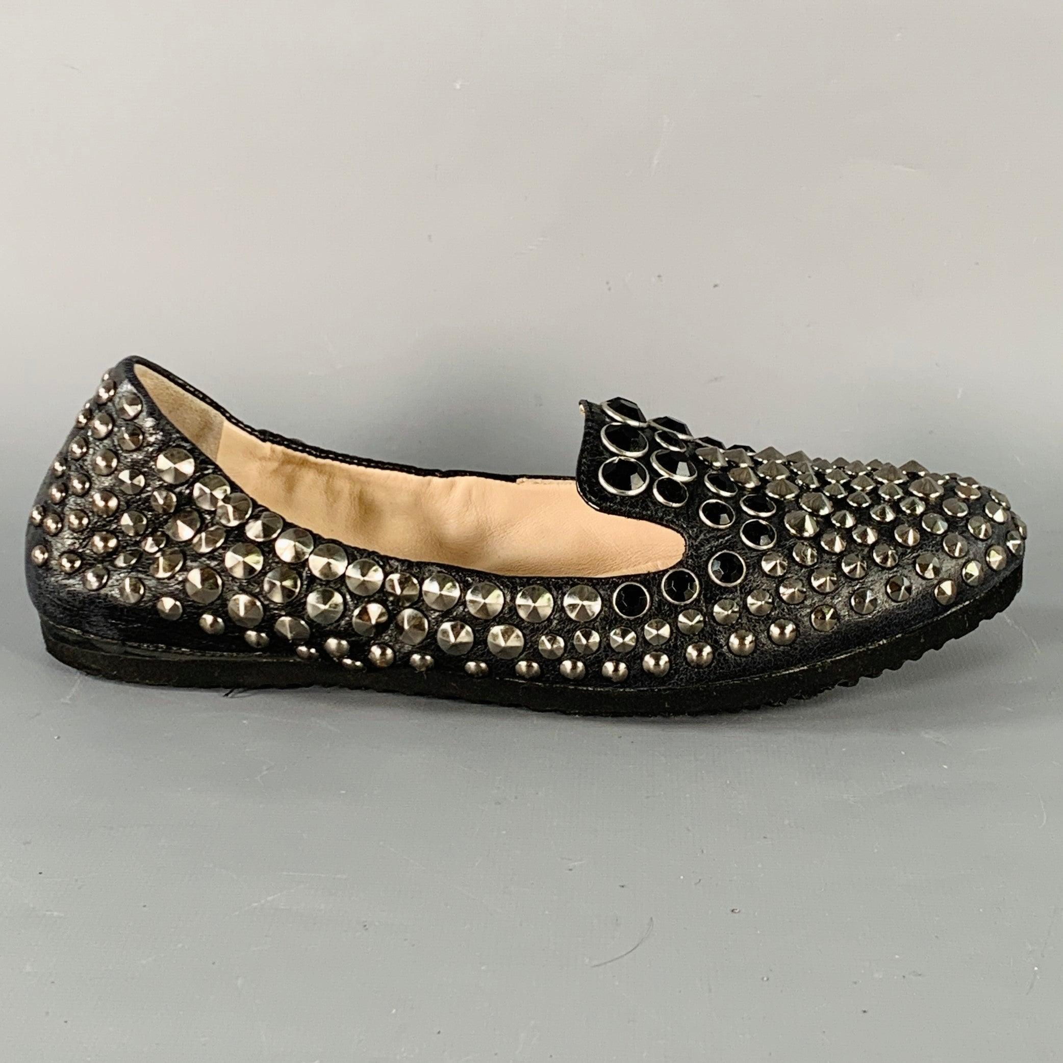 PRADA loafers in a black leather featuring an all over silver tone metal studded design with black stone details, and slip on closure.Very Good Pre-Owned Condition.
Minor signs of wear. 

Marked:   3S 5716FG015 37.5Outsole: 9.5 x 3 inches 
  
  
