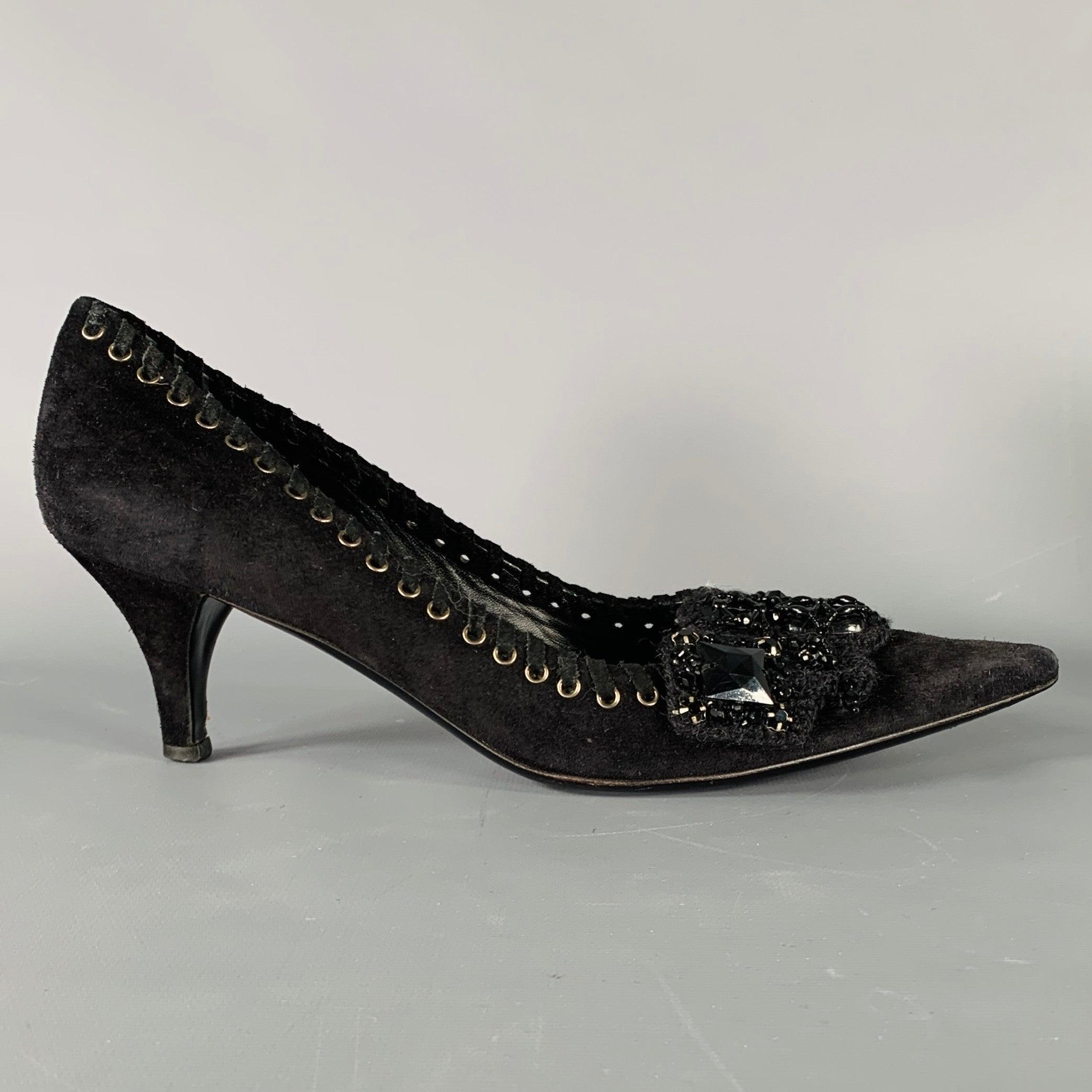 Vintage PRADA pumps
in a black suede fabric featuring beaded embellishment, silver tone grommet trim with suede laces, and pointed toe. Made in Italy.Very Good Pre-Owned Condition. Moderate signs of wear. 

Marked:   37.5 

Measurements: 
  Heel: