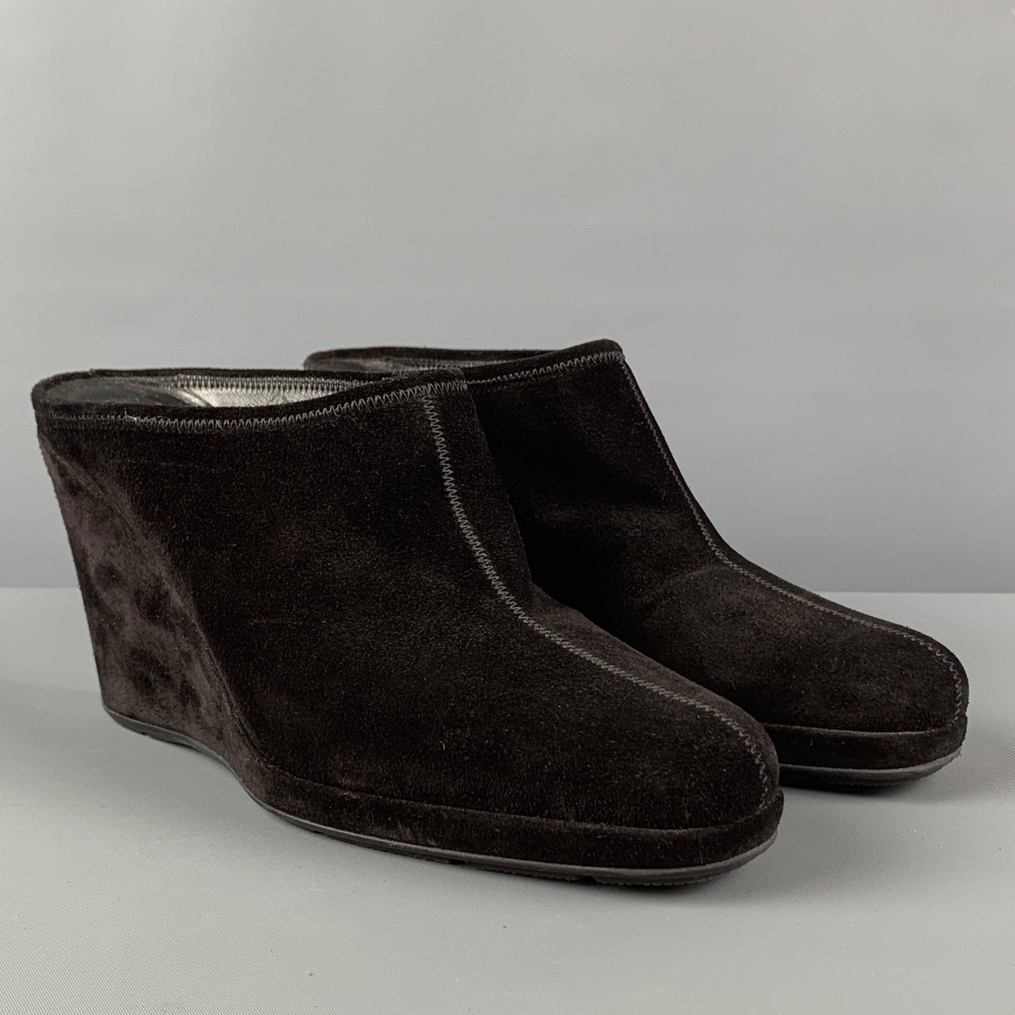PRADA boots comes in a black suede featuring a slip on style and a wedge heel. Made in Italy.
 Good
 Pre-Owned Condition. 
 

 Marked:  37.5 
 

 Measurements: 
  Heel: 3.25 inches 
  
  
  
 Sui Generis Reference: 120671
 Category: Boots
 More