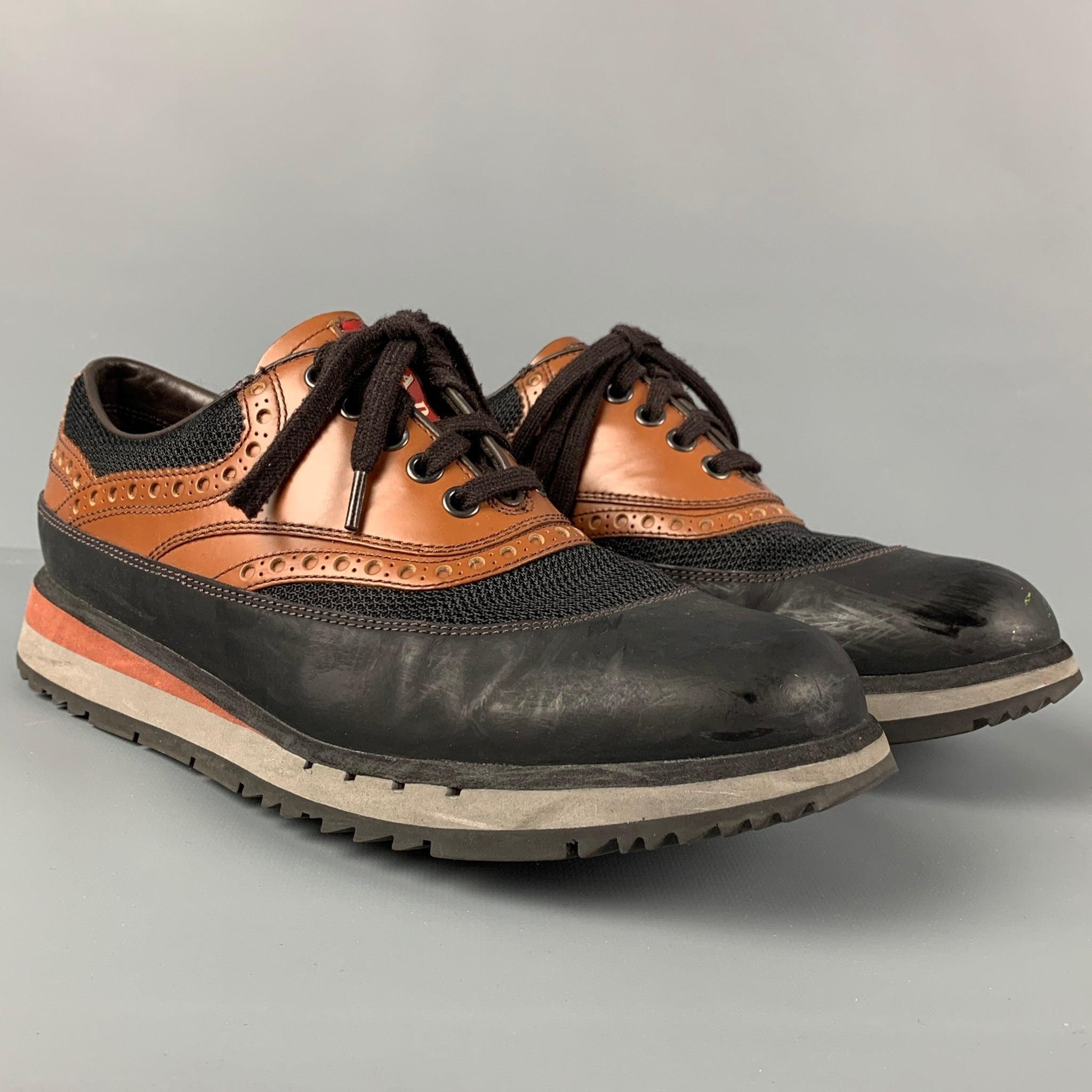 PRADA sneakers comes in a black & tan leather featuring a mesh panel, rubber sole, and a lace up closure.
Very Good
Pre-Owned Condition. 

Marked:   7.5Outsole: 11.5 inches  x 4.25 inches 
  
  
 
Reference: 115710
Category: Sneakers
More Details
  