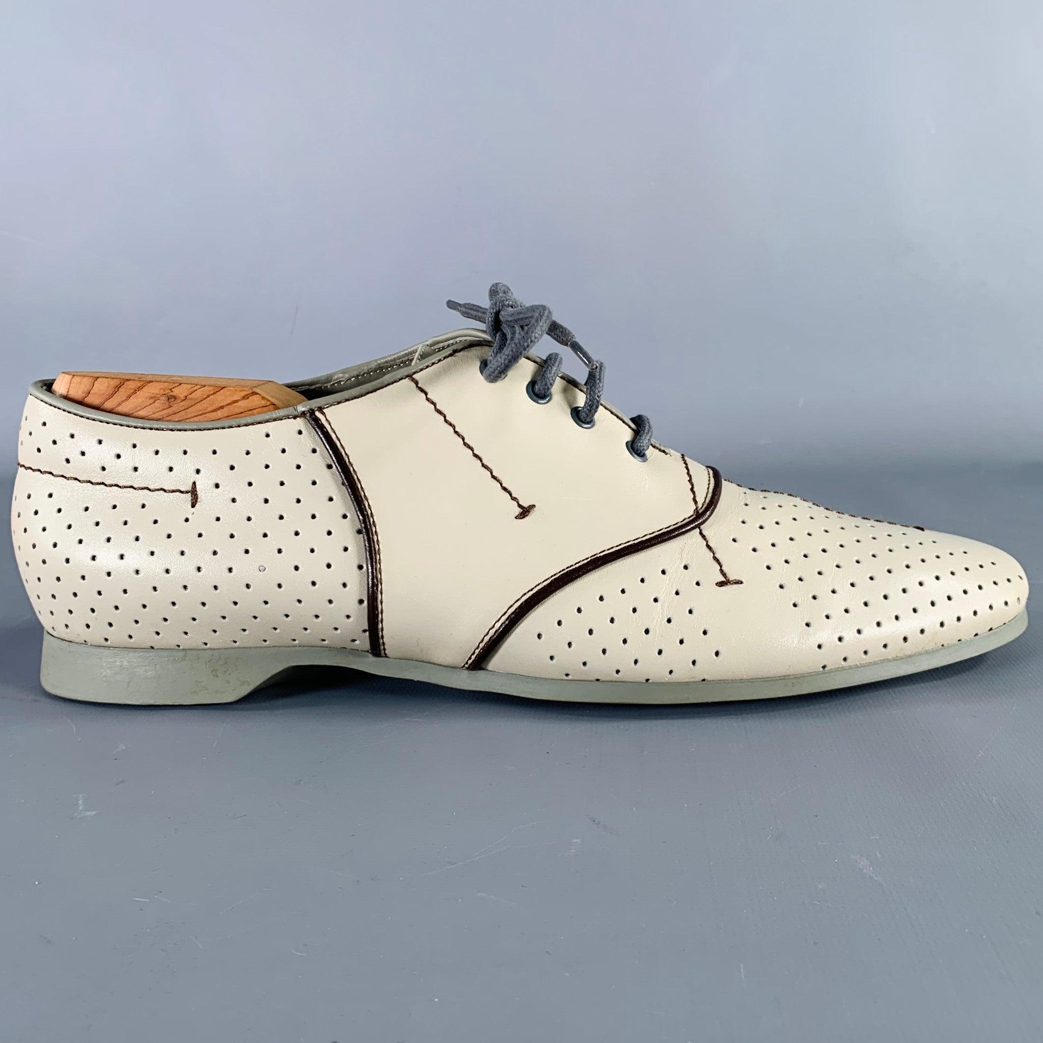 PRADA SPORT shoes
in a grey leather featuring a perforated design, brown leather trim, and lace-up closure. Made in Italy.Excellent Pre-Owned Condition. 

Marked:   3E0213 40.5Outsole: 11.25 x 3.25 inches 
  
  
 
Sui Generis Reference: