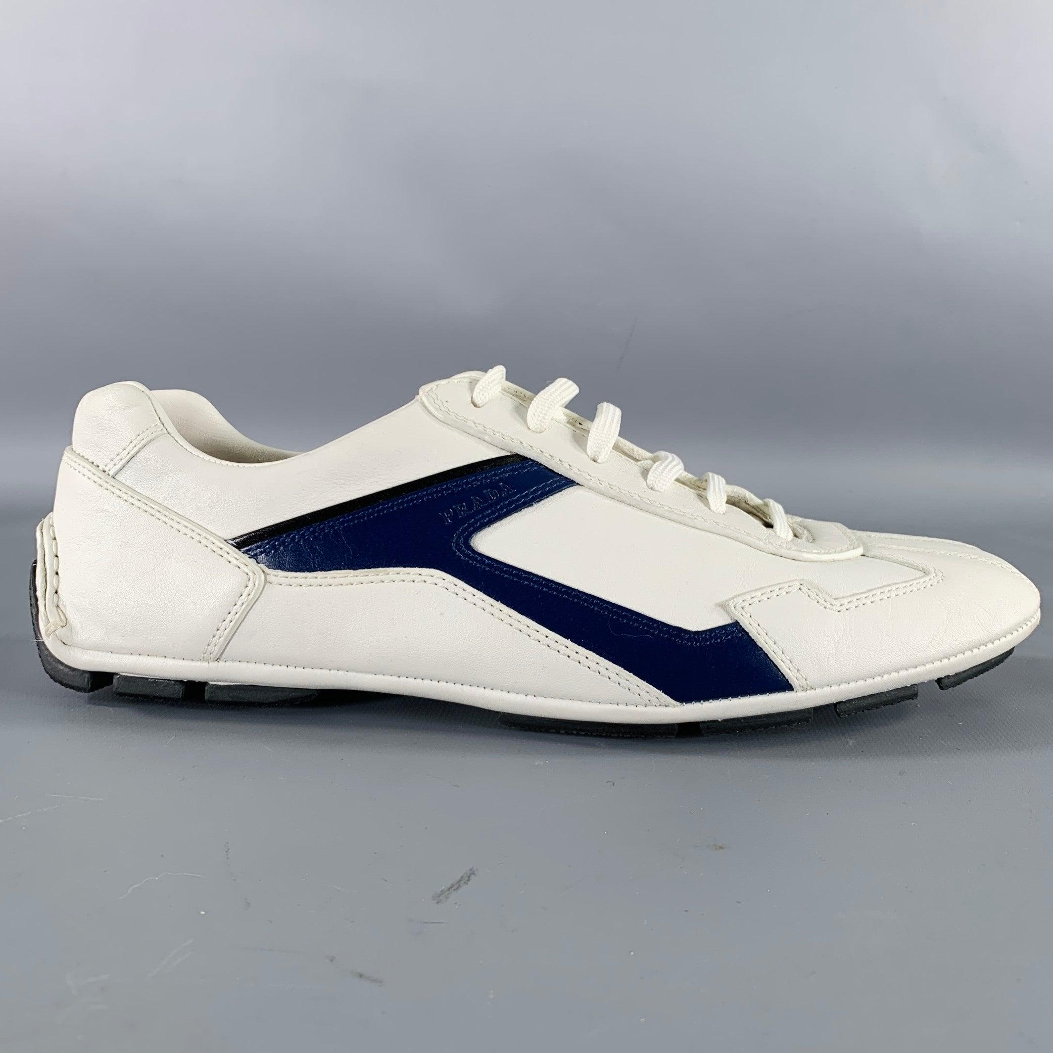PRADA -Monte Carlo- sneakers
in a white and navy leather featuring a color block style, low top, and lace-up closure. Comes with box. Excellent Pre-Owned Condition. 

Marked:   4E 2791 6.5Outsole: 10.5 inches  x 3.5 inches 
  
  
 
Sui Generis