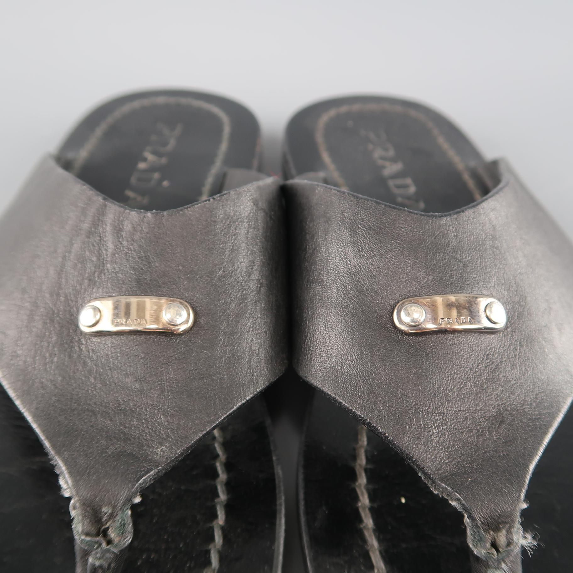 PRADA thong sandals come in black leather with thick V straps detailed with silver tone metal logo. Made in Italy.
 
Very Good Pre-Owned Condition.
Marked:UK 7
 
Outsole: 11 x 4.45 in.
