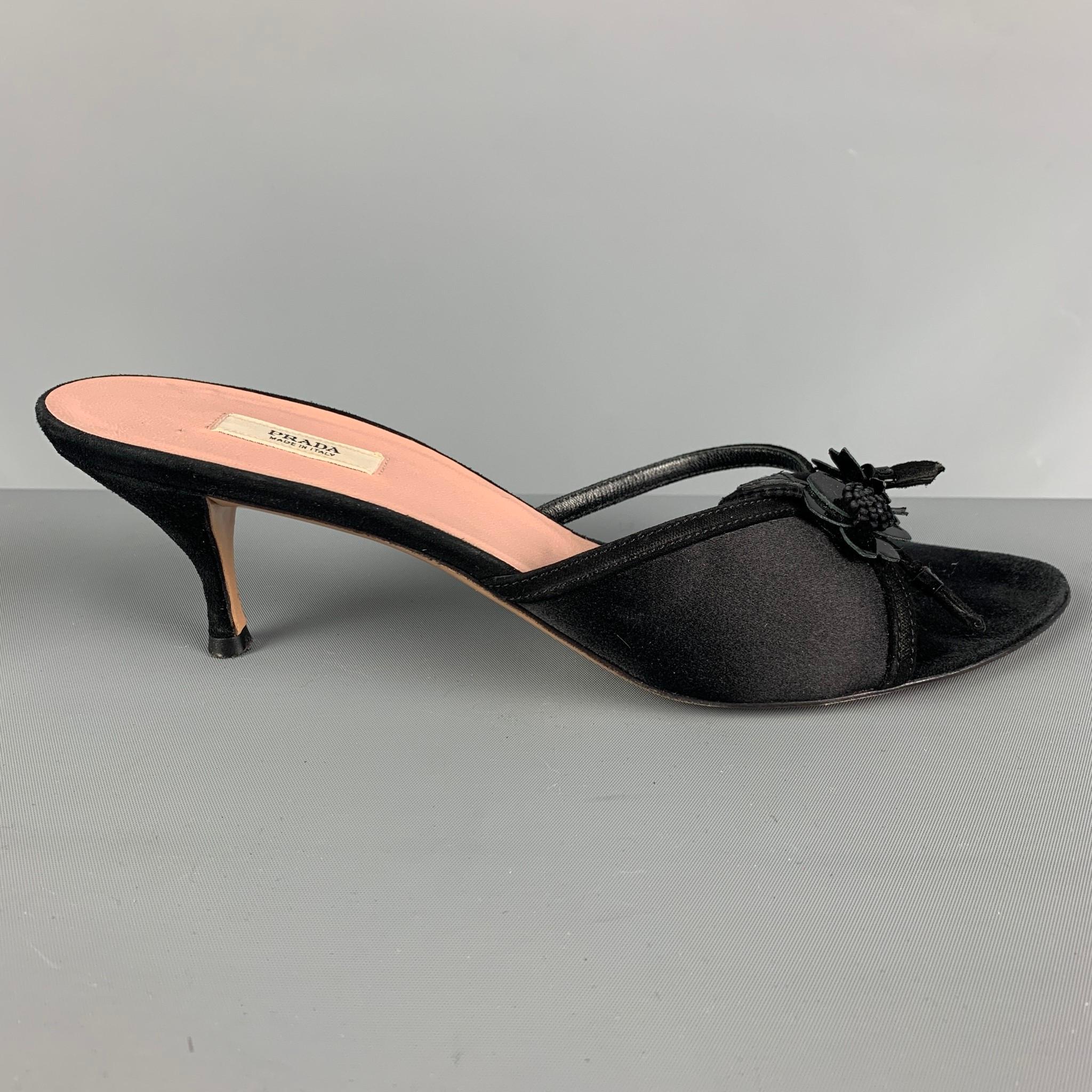 PRADA mule sandals comes in black silk patent leather featuring flower appliques embellishment at straps, and kitten heels. Made in Italy.

Very Good Pre-Owned Condition. Minor Wear.
Marked: US 38

Heel: 2.5 in. 

 

SKU: 117833
Category: