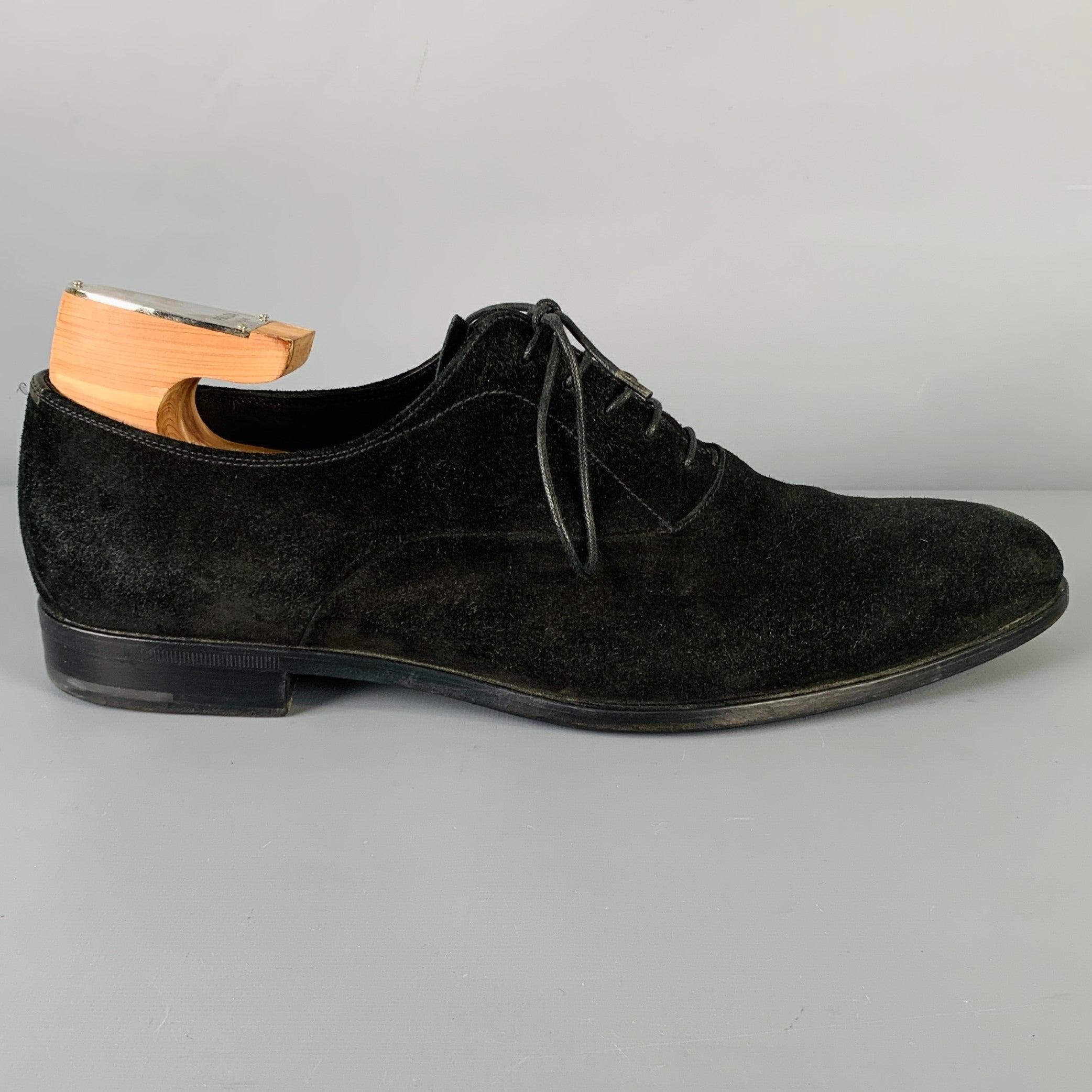 PRADA dress shoes
in a black suede fabric featuring an oxford style, pointed toe, and lace-up closure. Comes with shoe trees. Made in Italy.Very Good Pre-Owned Condition. Minor signs of wear, shoe trees as is. 

Marked:   2EA 099 8Outsole: 12.5